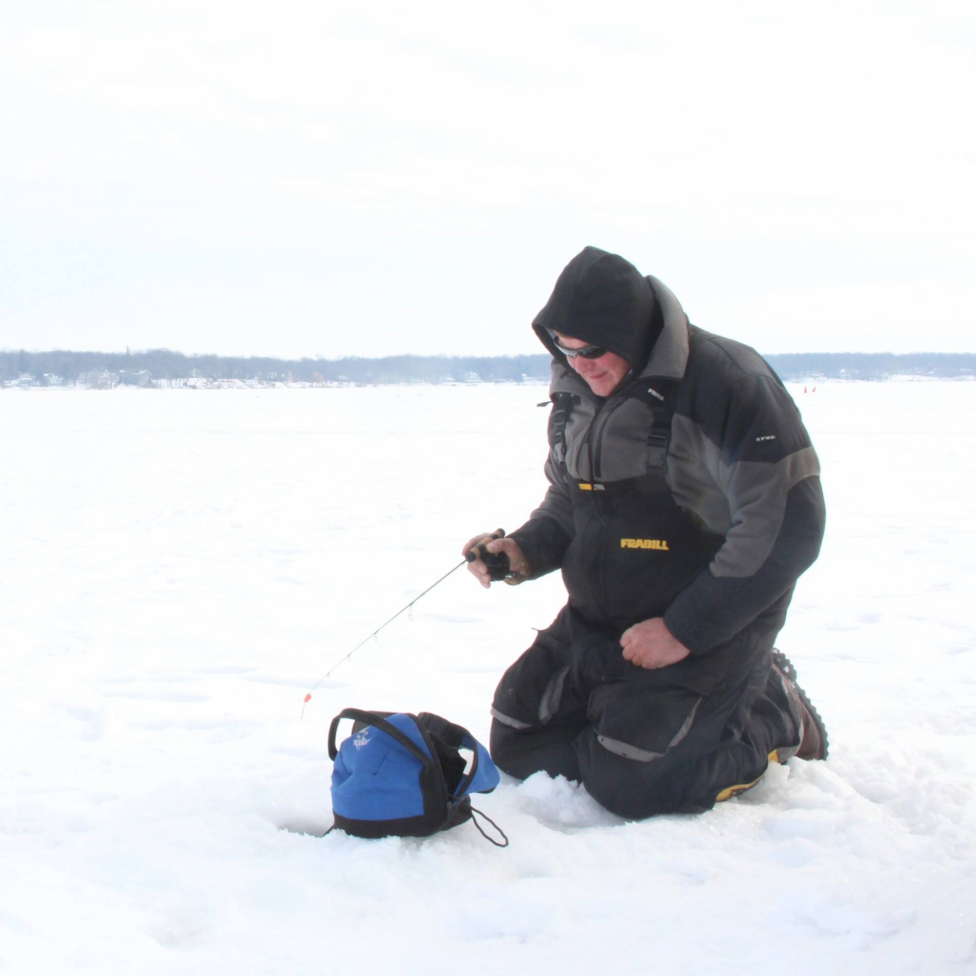 Lake trout fishing on Geneva Lake Wisconsin with guide John Reddy and ice fishing equipment