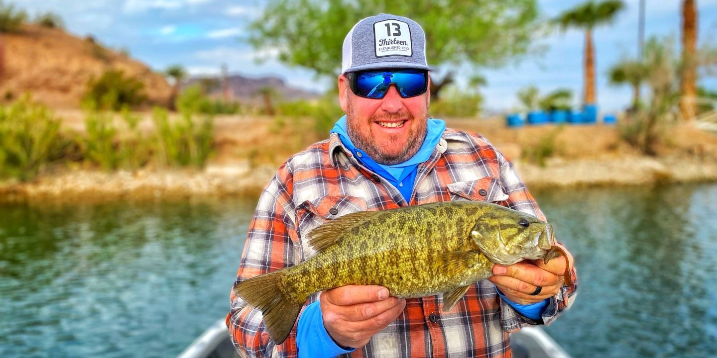 Bass fishing boat on Arizona lake with angler casting rod, Greater Phoenix area guided trip