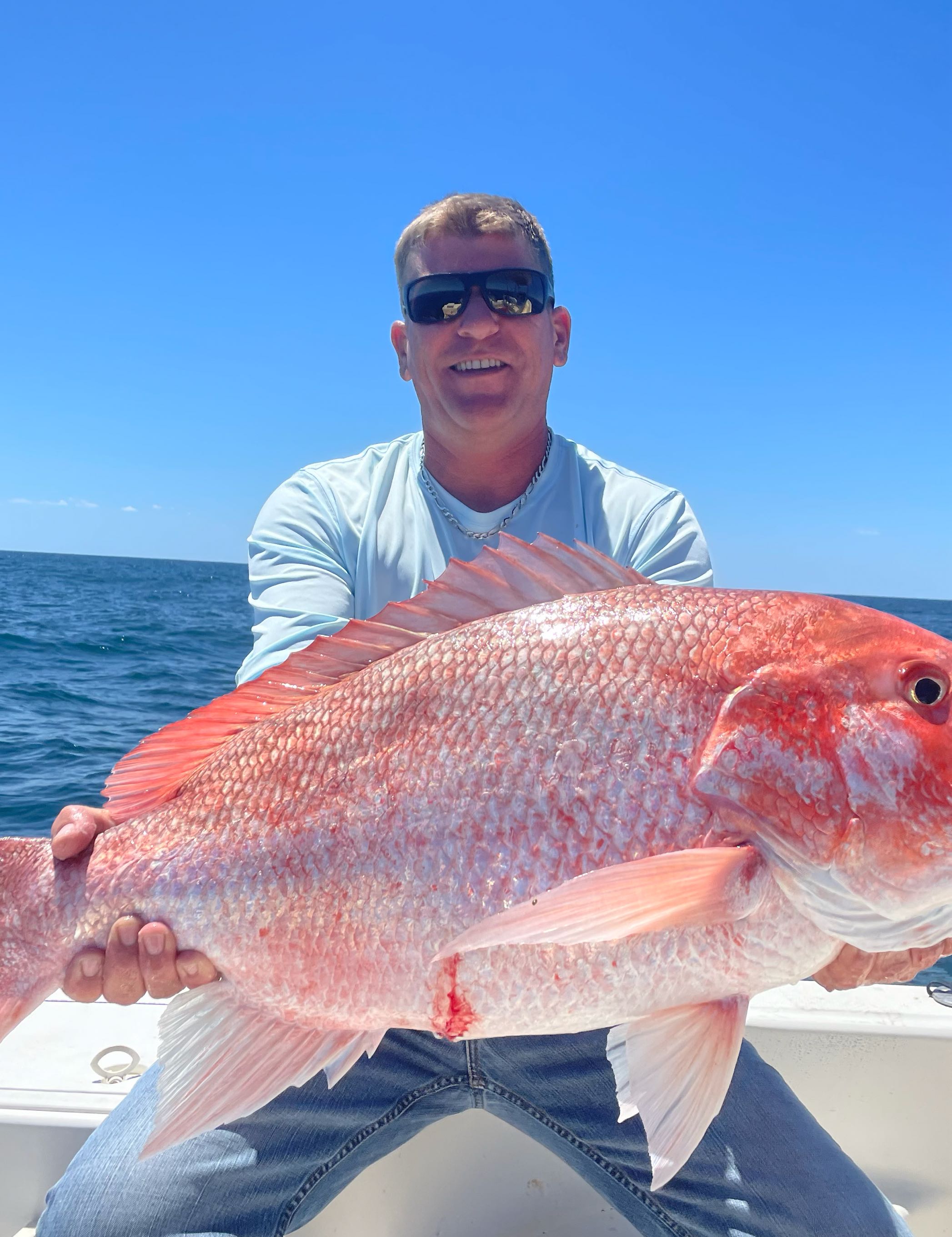 A single fisherman with a great catch in Micco