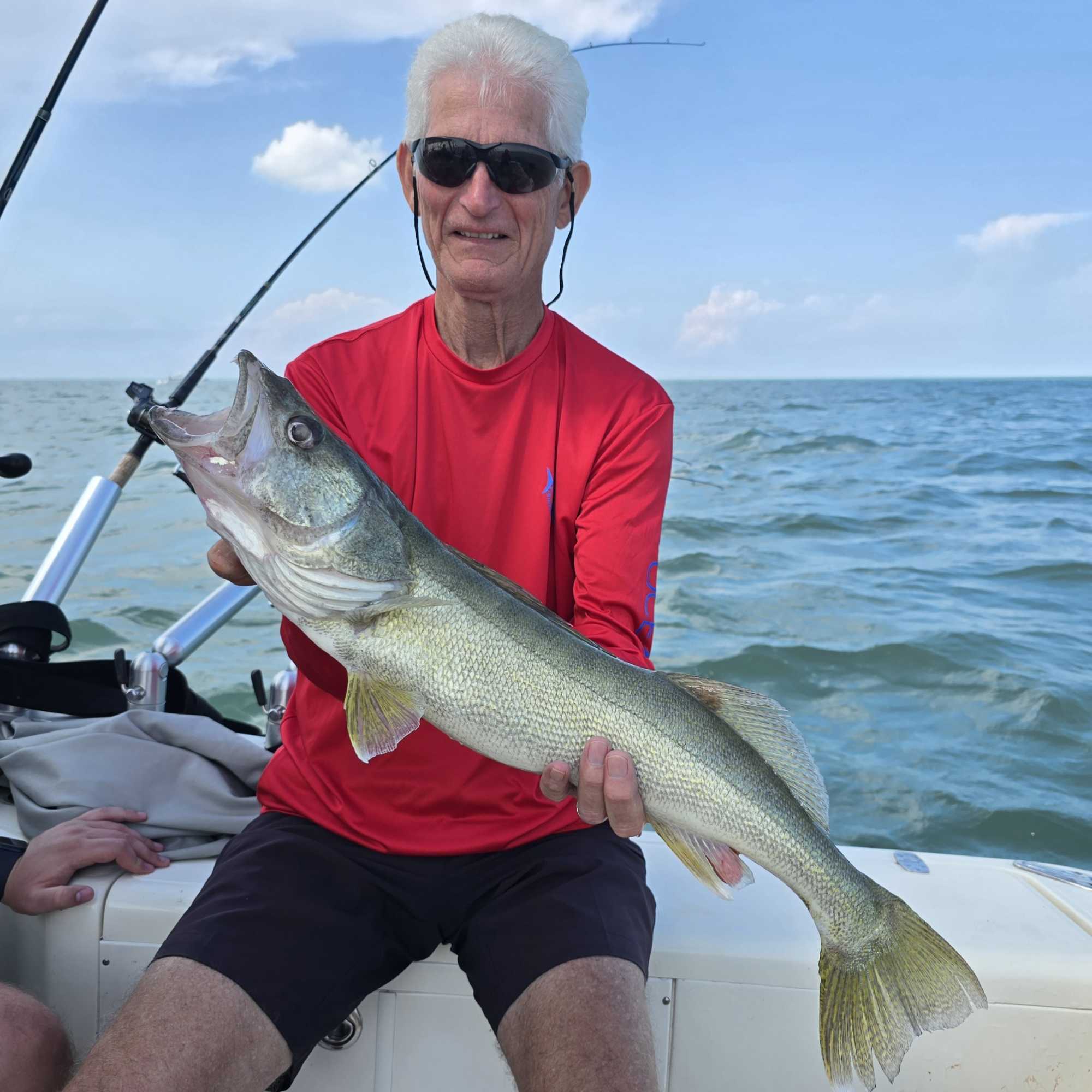 Angler holding caught fish on fishing boat at Lakeside Marblehead OH