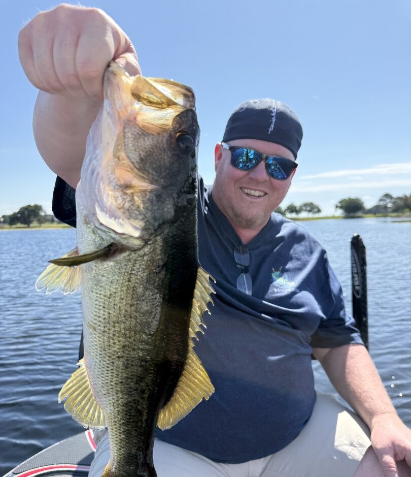 Large bass fish being held up after successful catch in Winter Garden FL