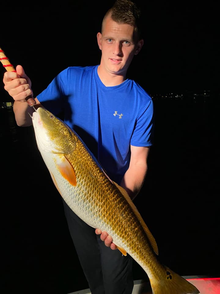 Fisherman holding a 23-inch fish in FL