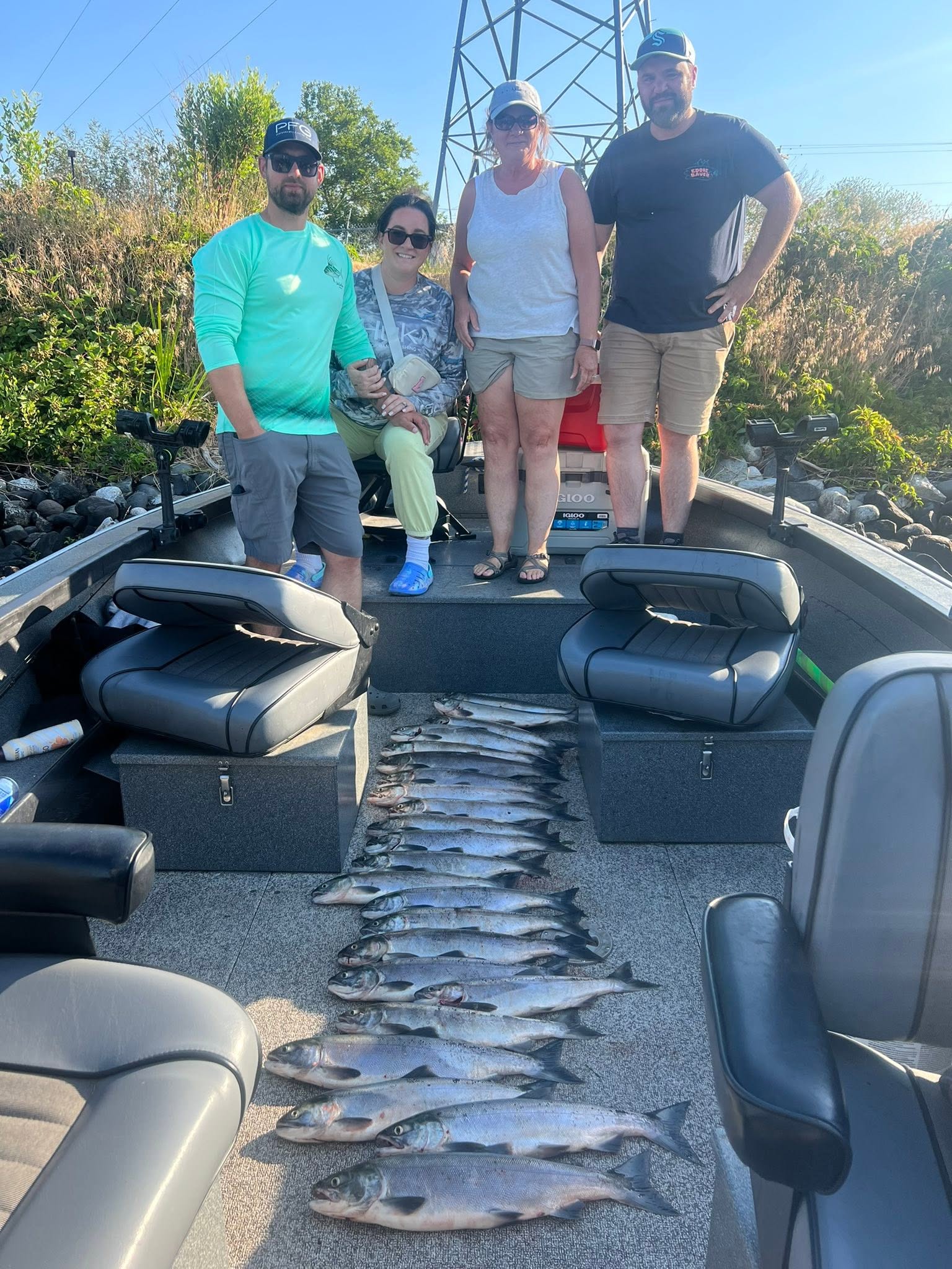 Successful salmon fishing trip in Richland WA with impressive catch of Coho and Sockeye salmon displayed on boat deck