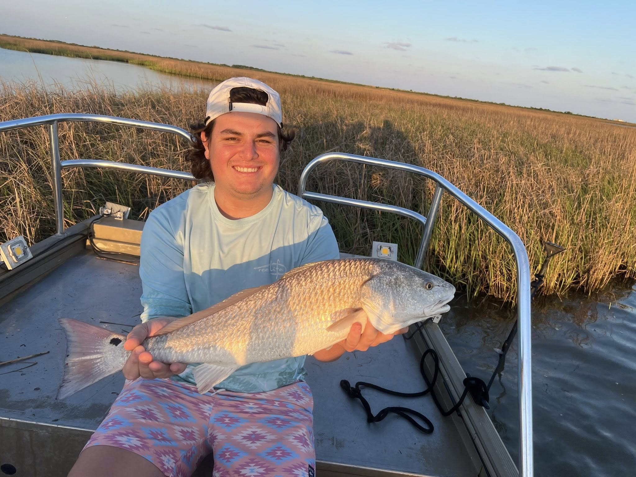 A person fishing for a redfish in Galveston