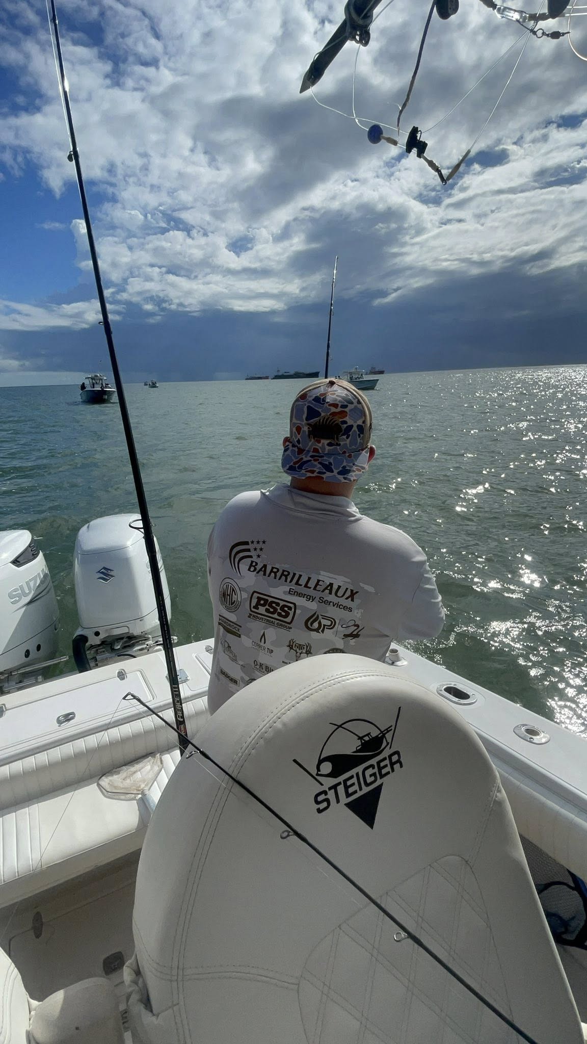Fishing boat on water in Galveston TX with fishing rod and outboard motor
