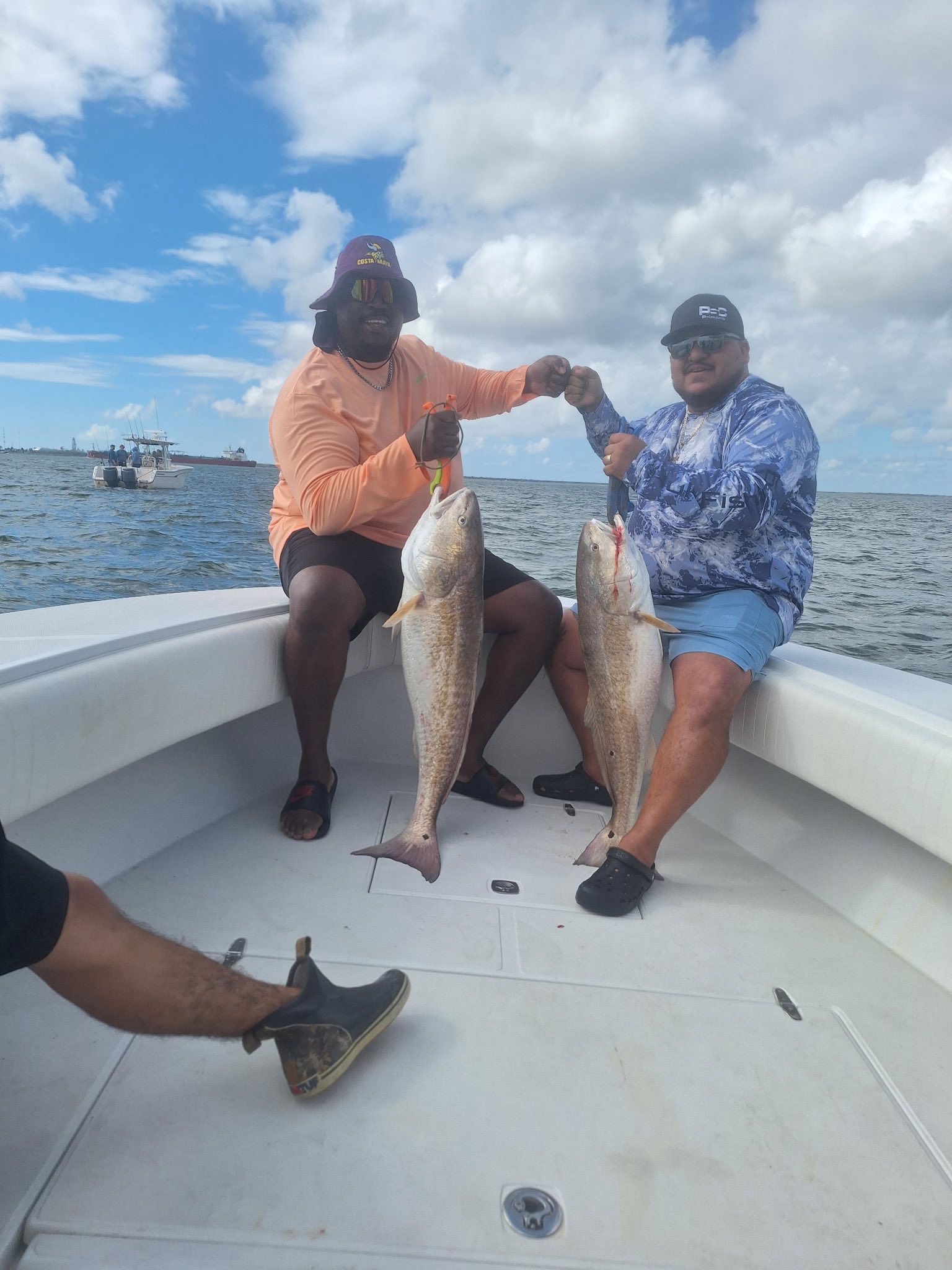 Two large redfish caught during fishing trip in Galveston TX displayed on boat deck