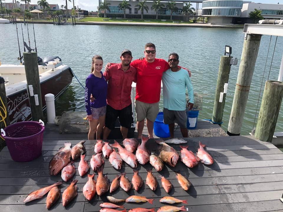 Four people enjoying a day at Madeira Beach