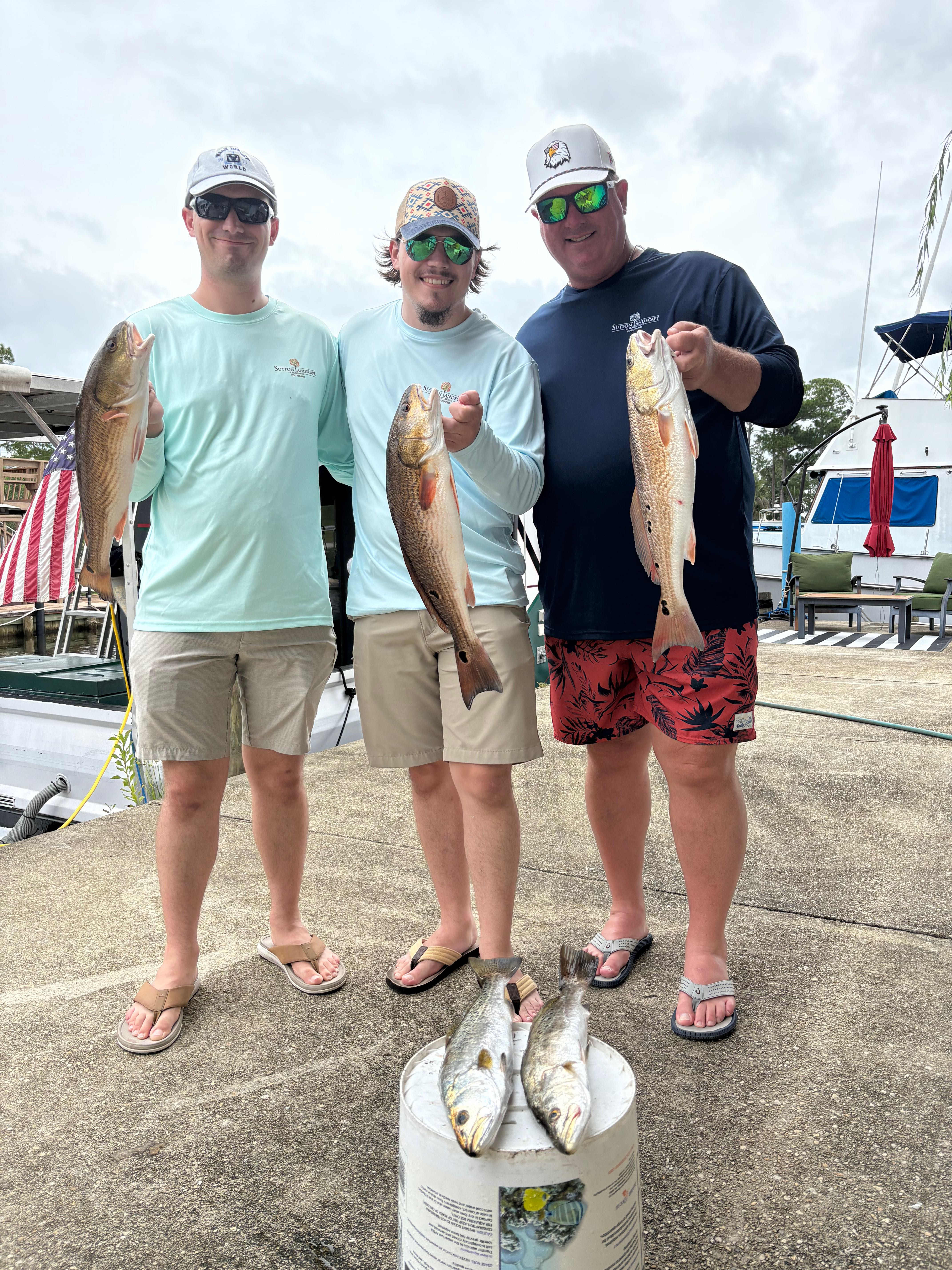 Successful fishing charter in Milton FL showing redfish and speckled trout catch