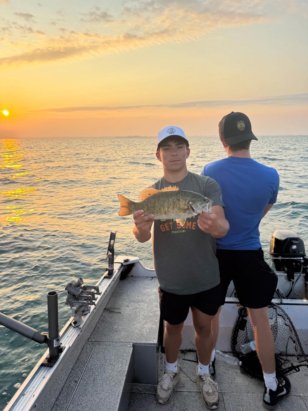 Smallmouth bass caught while fishing on boat in Detroit MI at sunset
