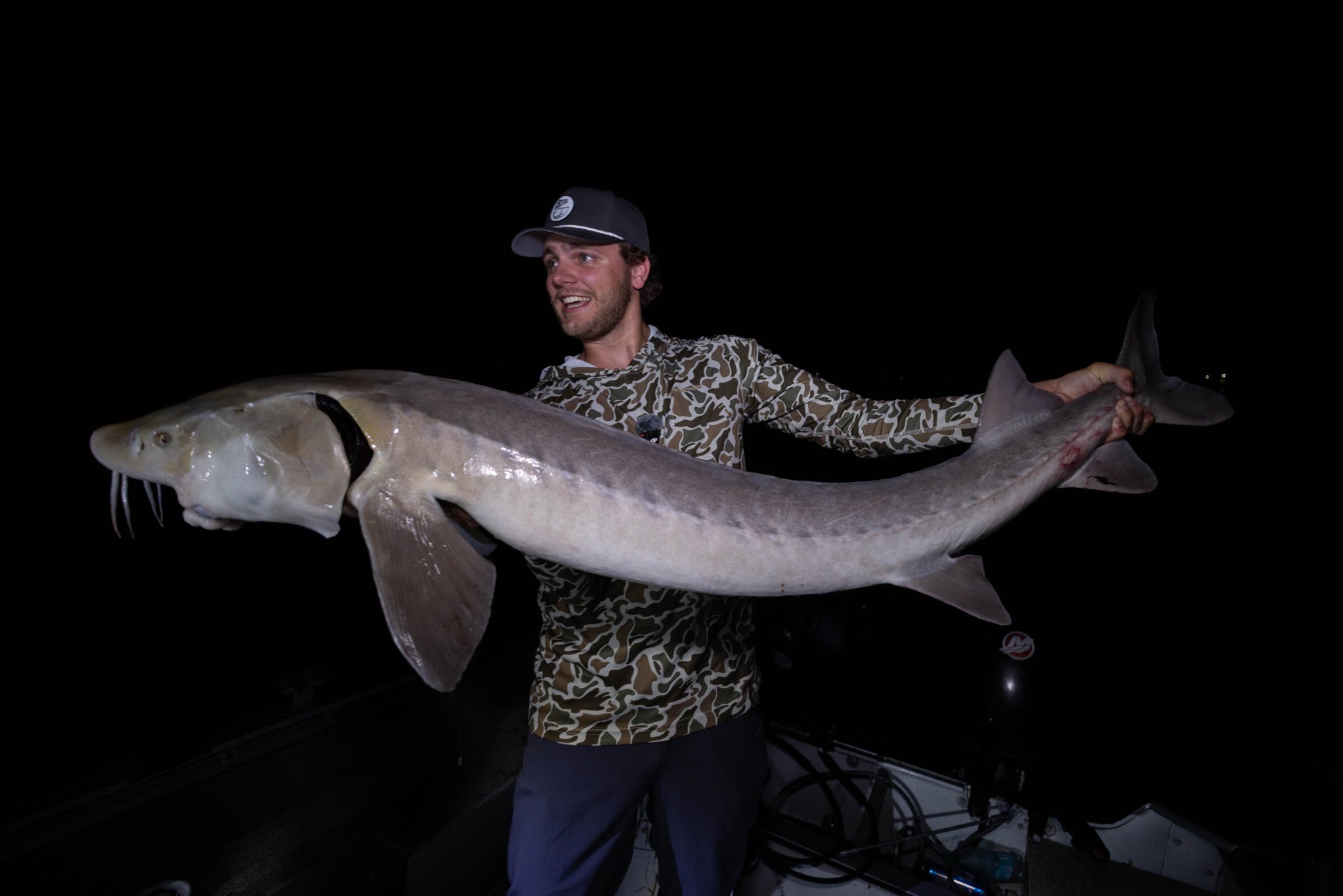 Night sturgeon fishing charter boat on Lake St. Clair Michigan with anglers and fishing gear