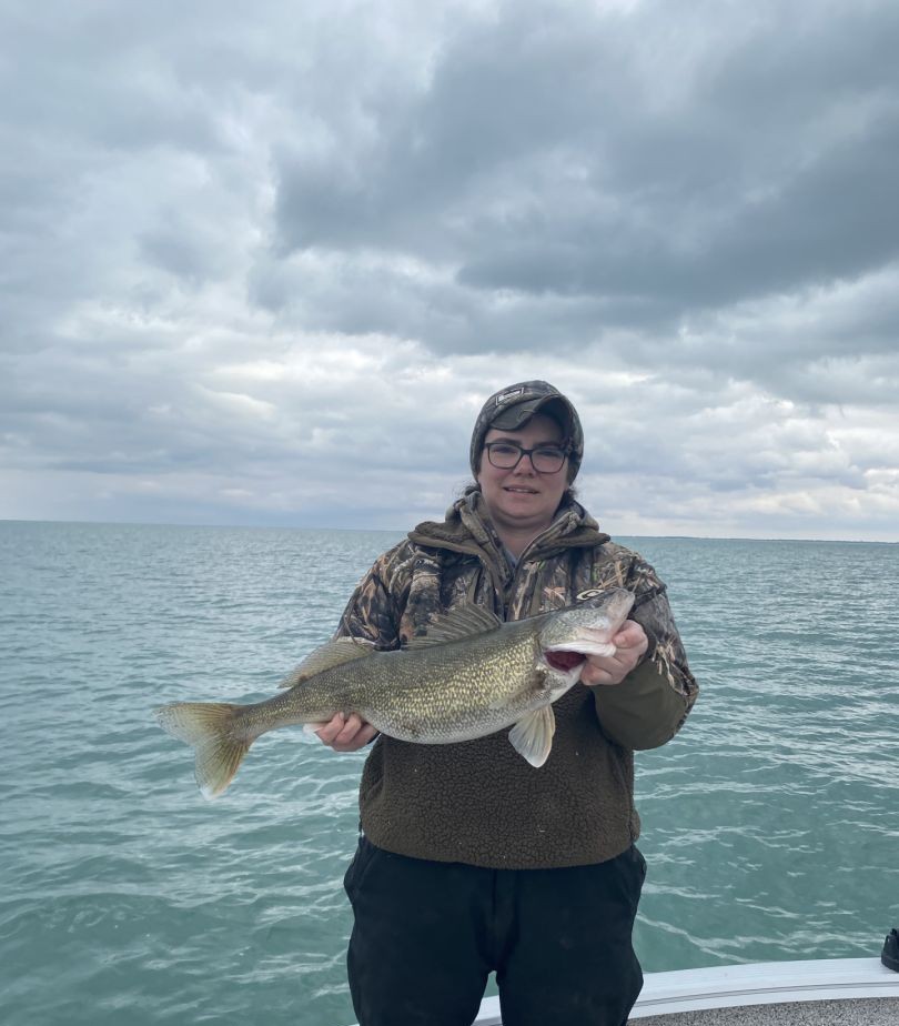 Detroit River walleye fishing charter boat with angler catching fish during spring migration