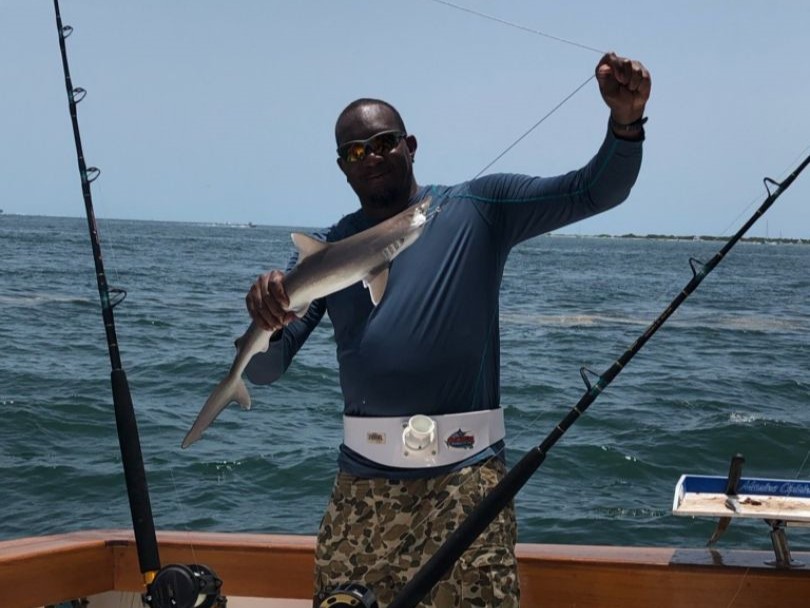 Tampa shark fishing charter boat with anglers using heavy tackle in Gulf of Mexico waters
