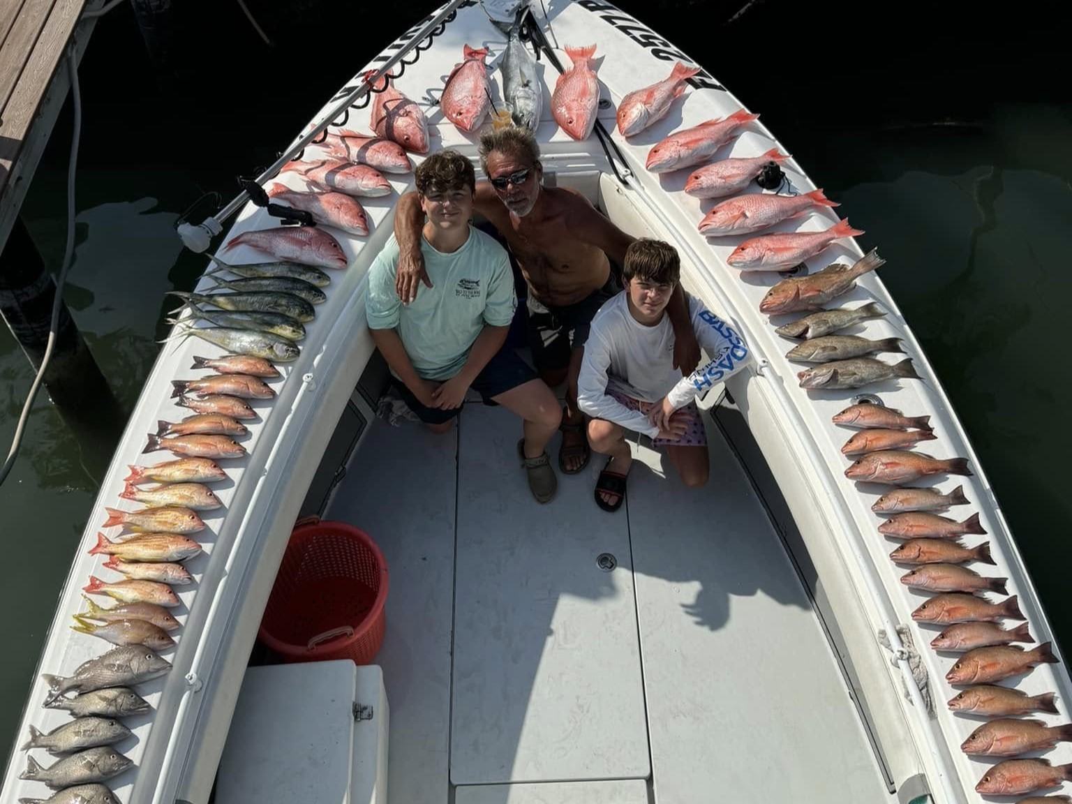 Tampa Bay nearshore fishing charter boat with anglers catching snapper and grouper
