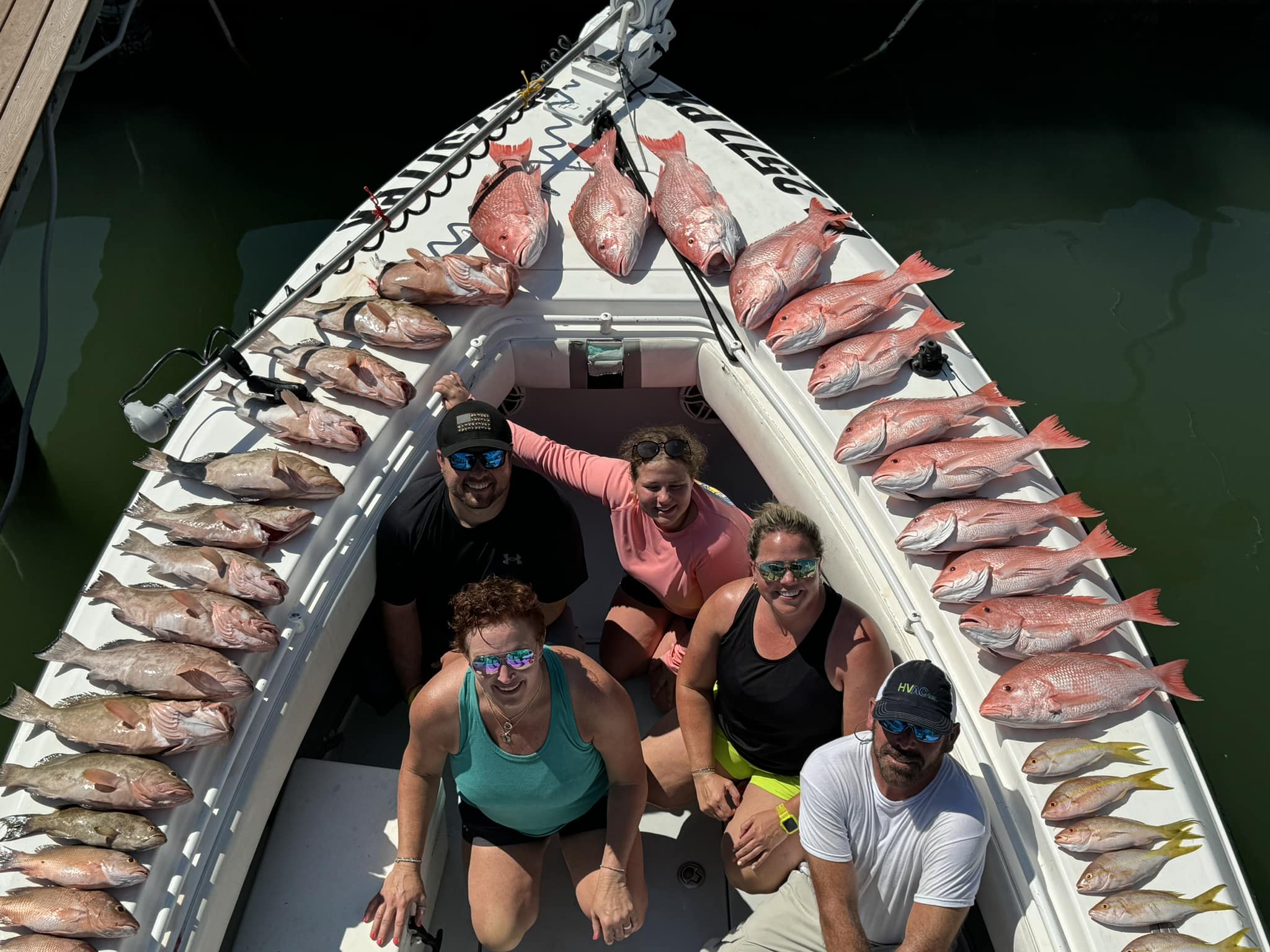Night shark fishing charter boat in Tampa Bay Gulf waters with fishing gear setup