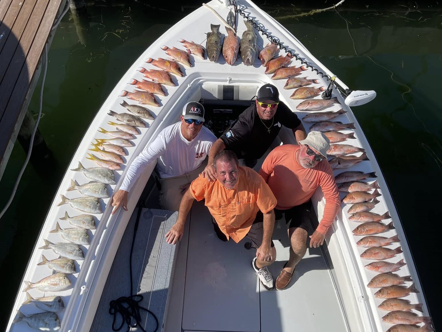Tampa Bay nearshore fishing charter boat with anglers catching snapper and grouper