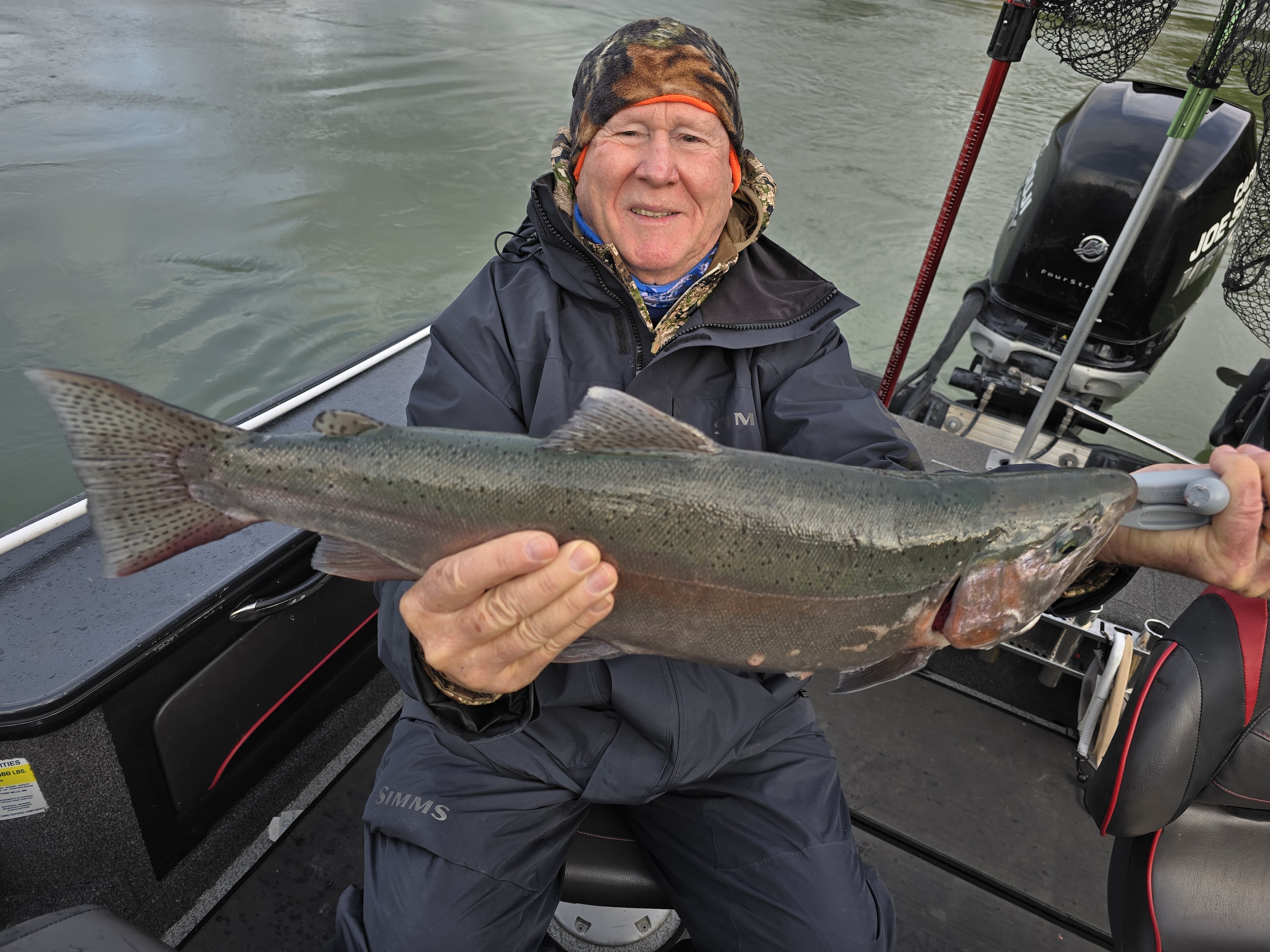 A person fishing for a pink salmon in NY