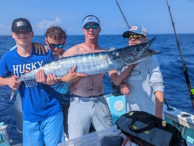 Deep sea fishing charter boat in Destin Florida waters with anglers targeting offshore species
