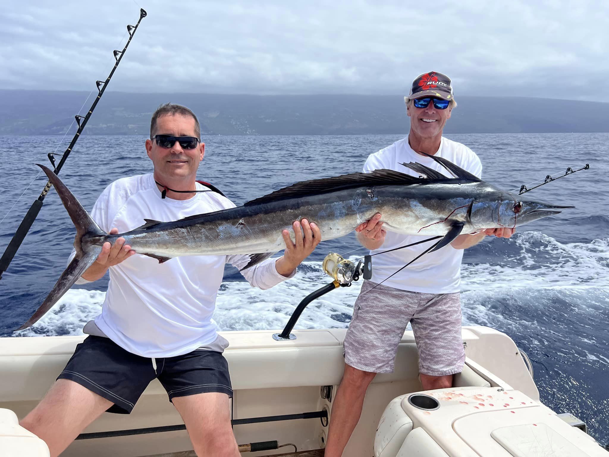 A large blue marlin being held by two people in Pittsburg