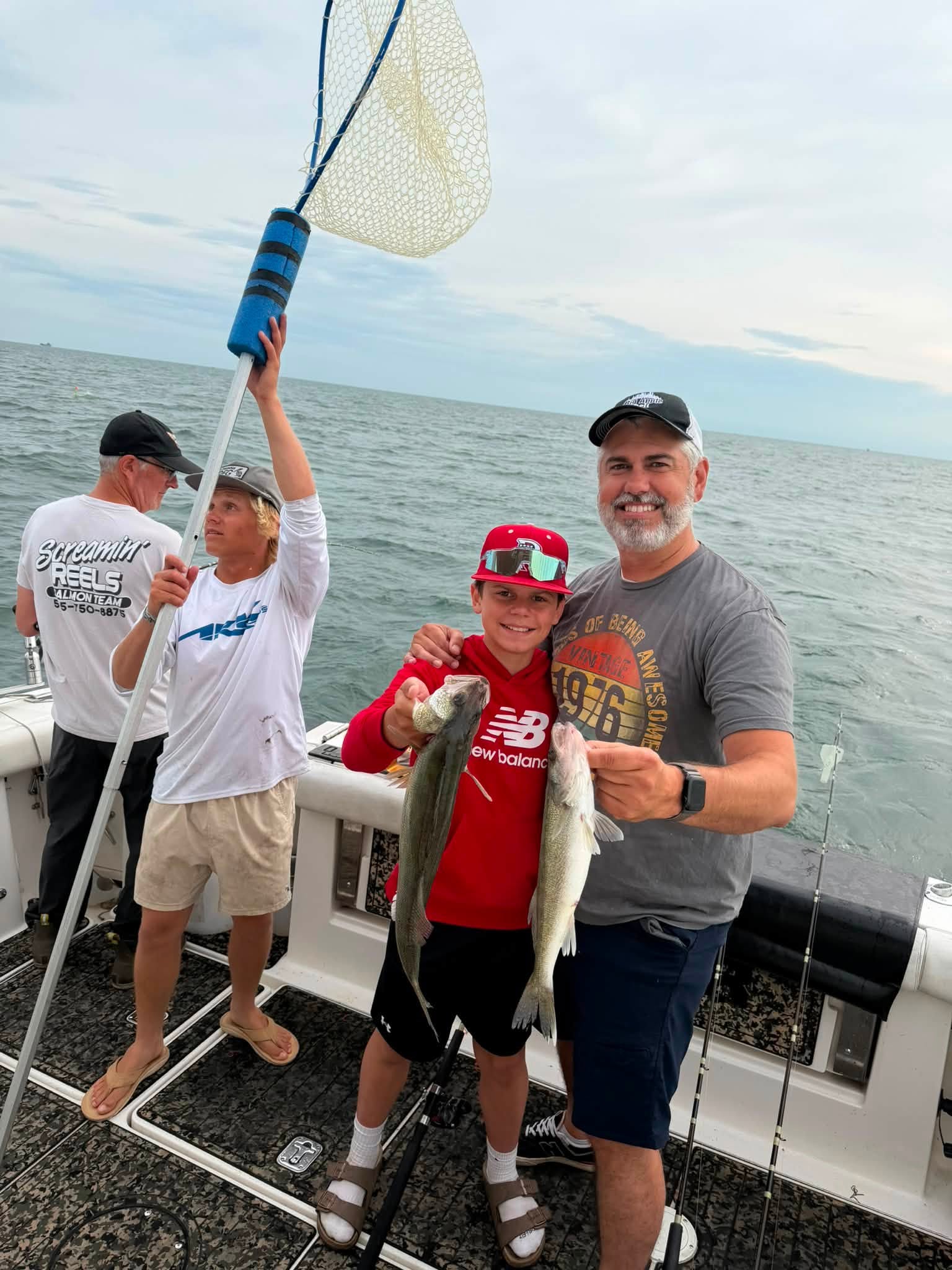 Successful fishing trip showing caught fish on boat deck with fishing net