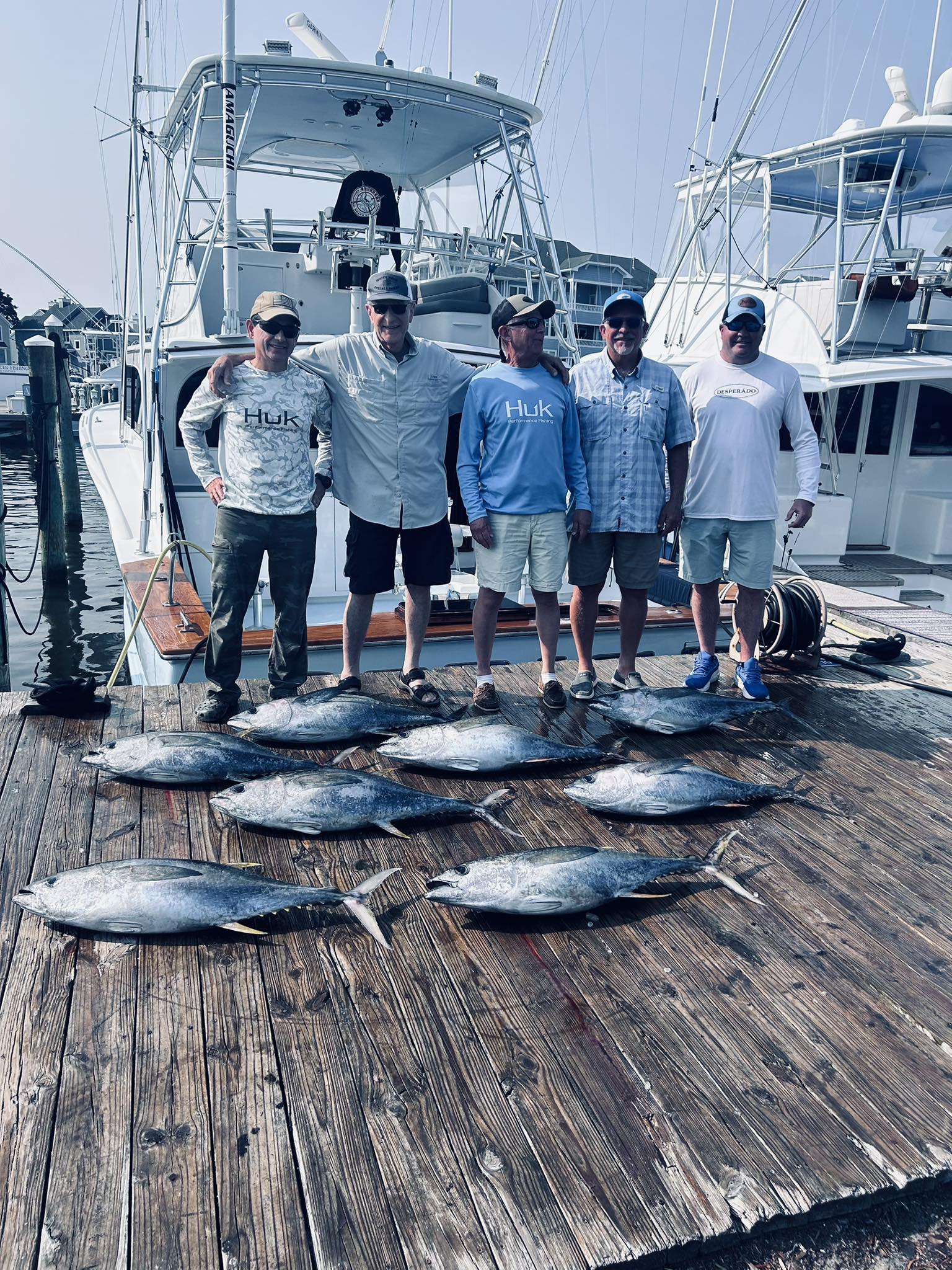 Successful yellowfin and bluefin tuna fishing charter in Manteo NC with multiple large tuna displayed on dock