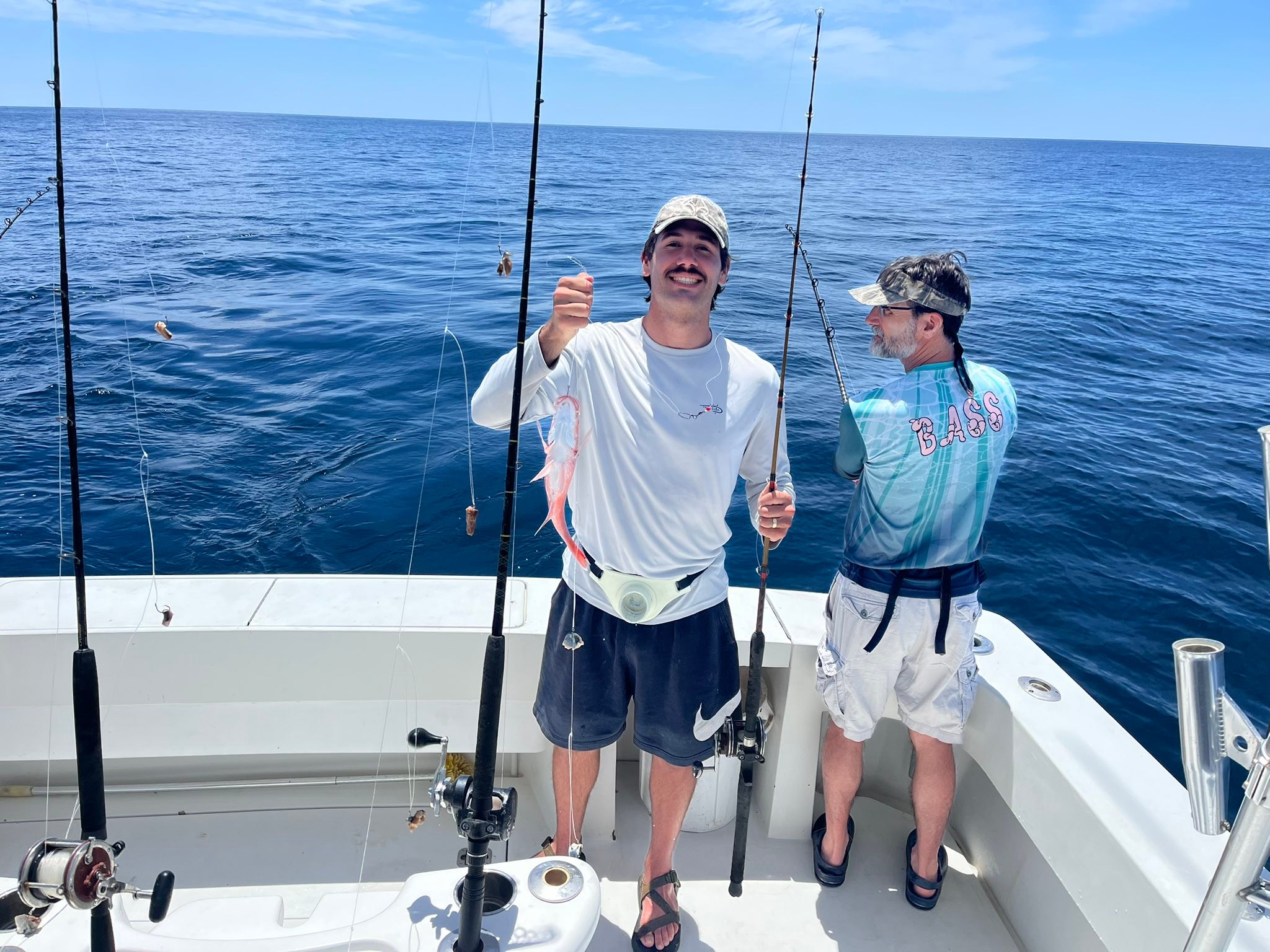 Fishing charter boat with multiple fishing rods and fresh caught fish in Destin FL waters