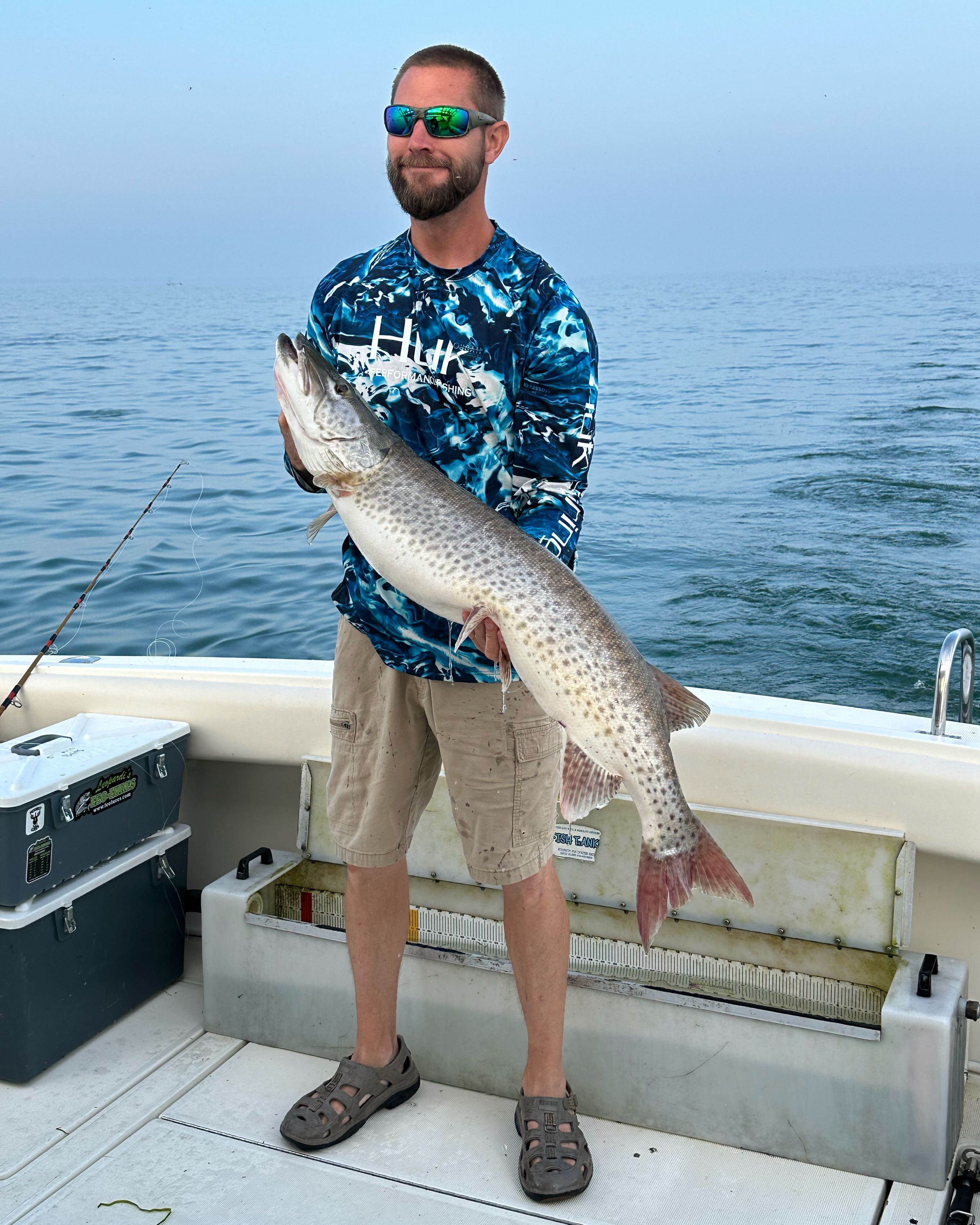 Fisherman holding a 26-inch freshwater fish in Michigan