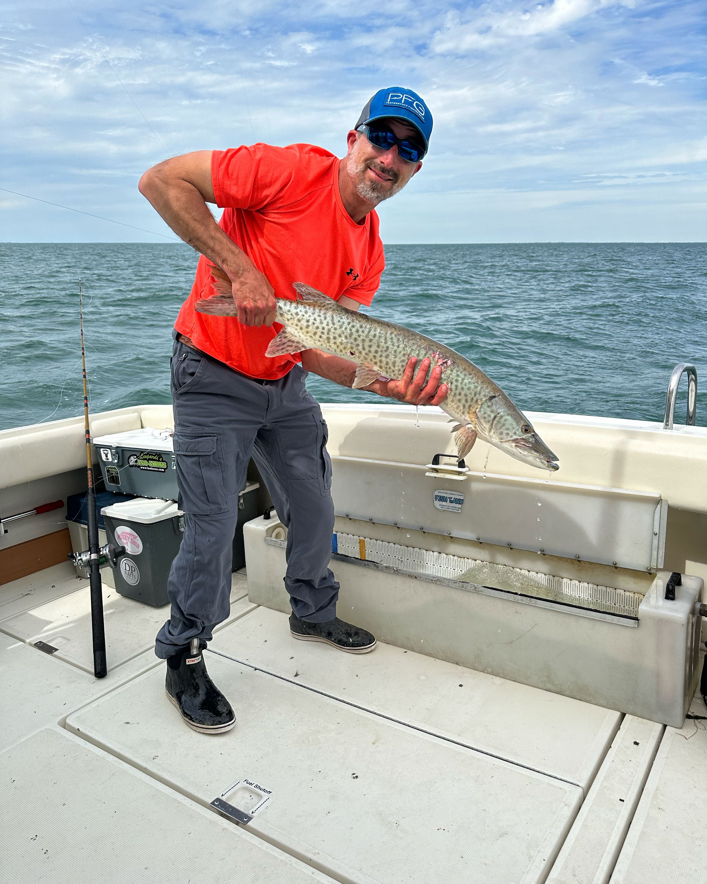 A fisherman holding a 16-inch fish caught in MI