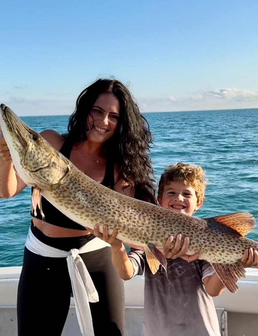 Two people fishing with an unseen catch at St. Clair Shores