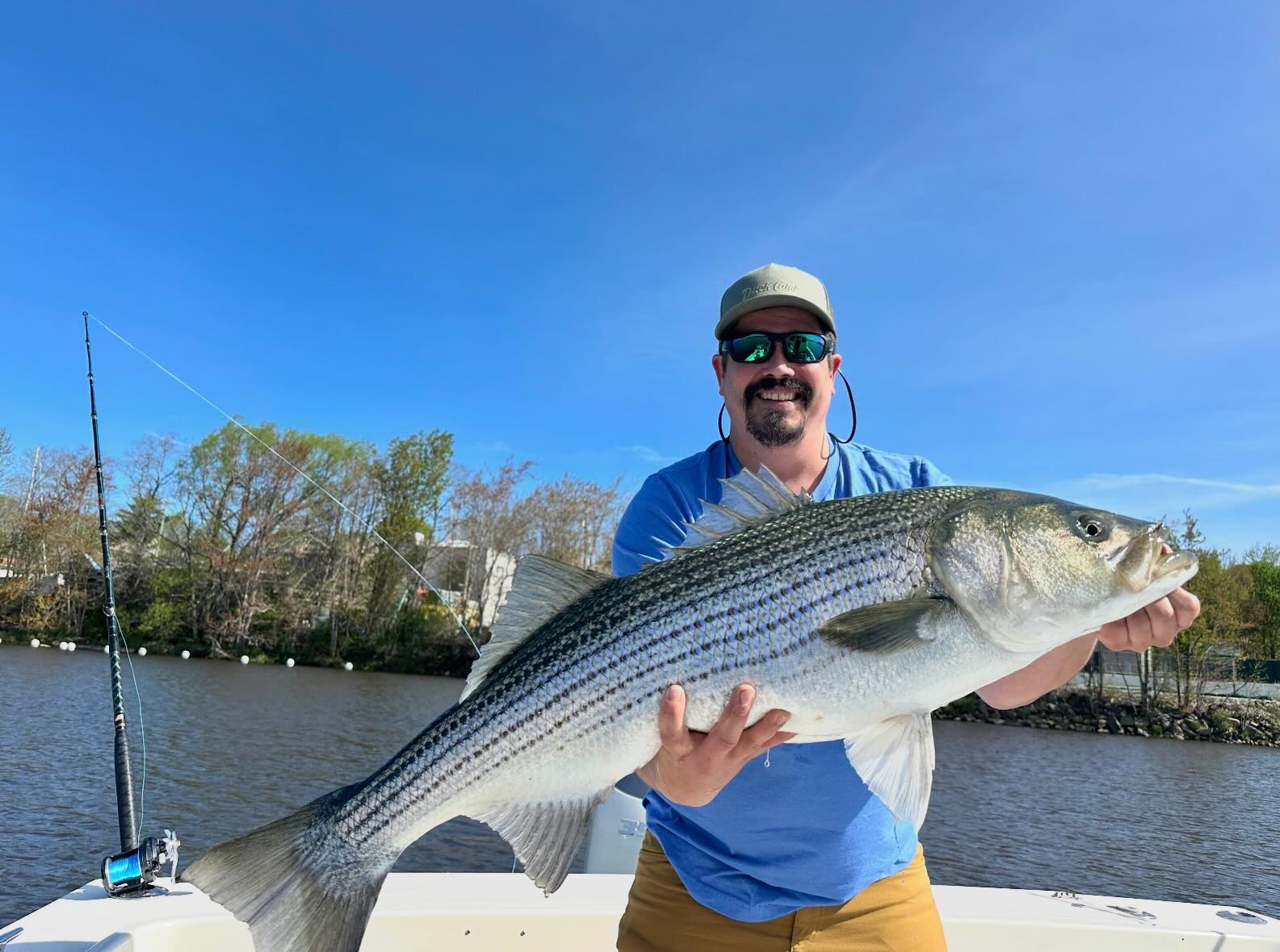 Half-day striped bass fishing charter boat in Wells Maine coastal waters with angler and guide
