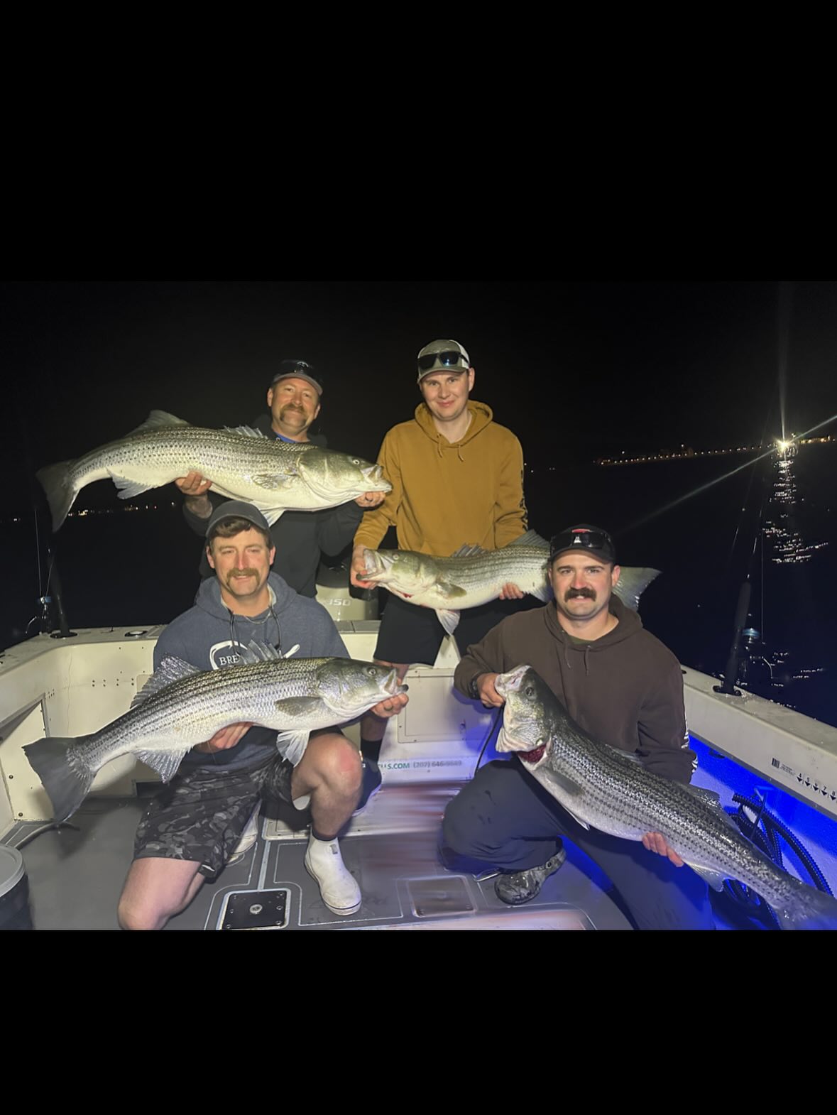 Night striped bass fishing charter boat in Wells Maine using sonar electronics at dusk