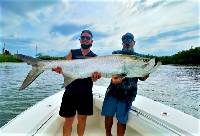 Anglers reeling in a 54-inch catch on a fishing cruise in PR