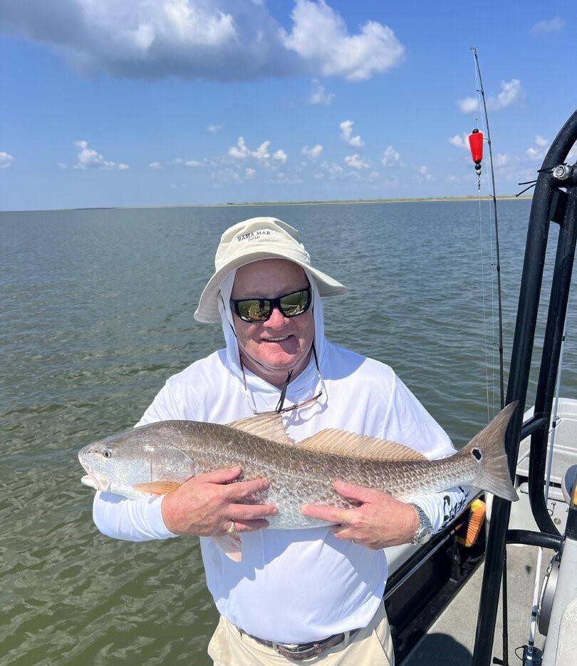 Angler holding large redfish on fishing boat in Venice Louisiana waters