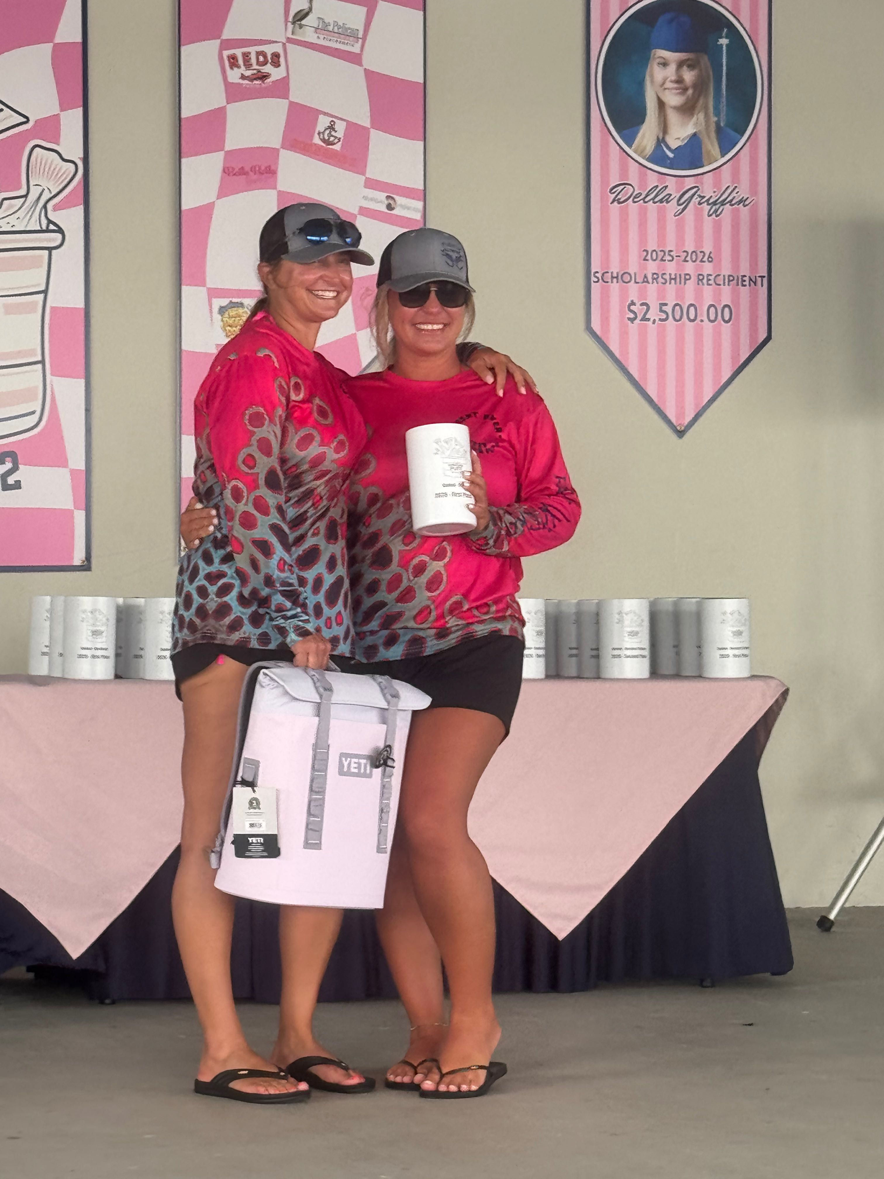 Fishing tournament award ceremony with winners holding trophy and prizes at outdoor event in Pleasanton TX