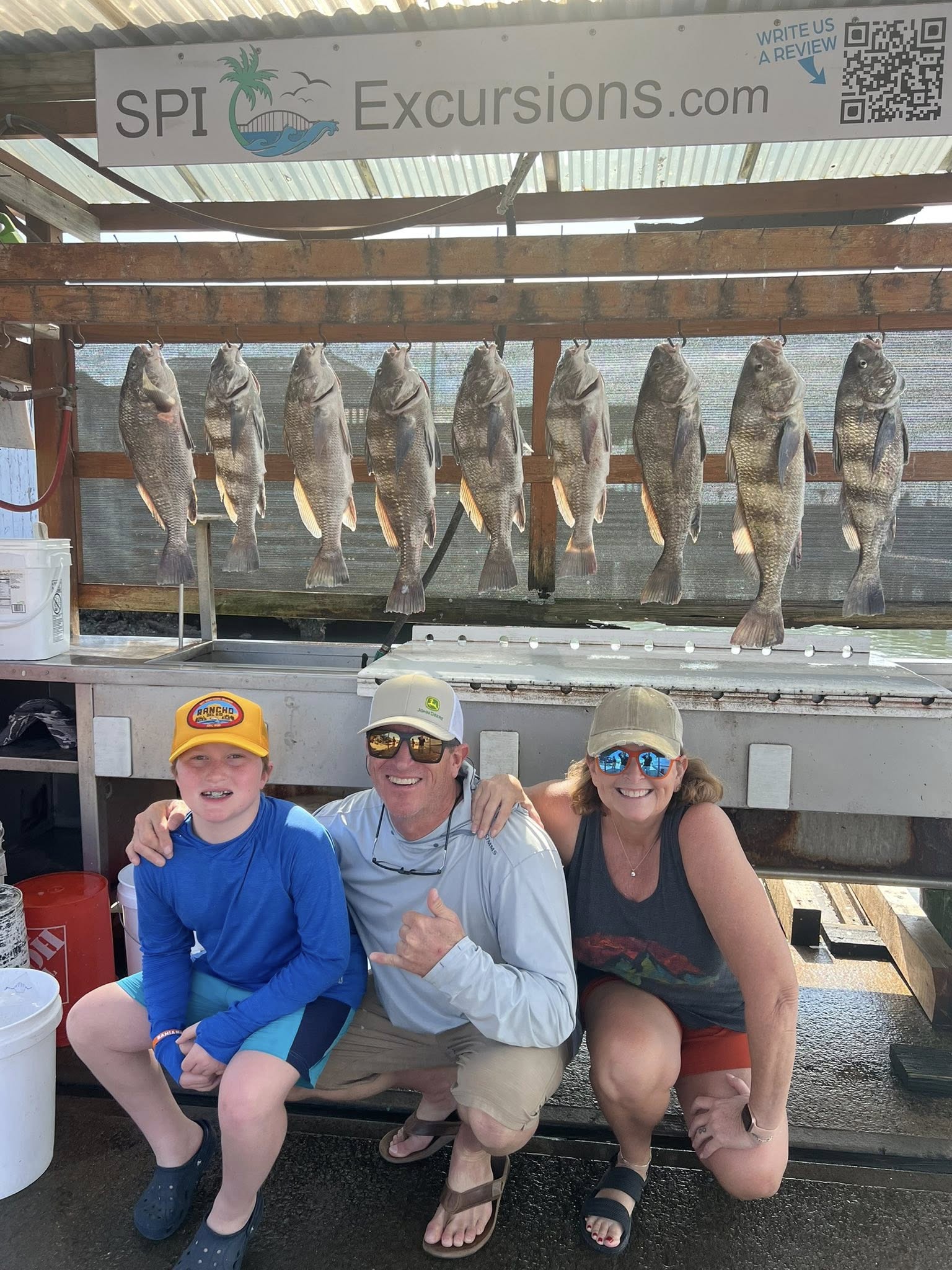 Nine black drum fish hanging on display rack after successful fishing trip in South Padre Island TX