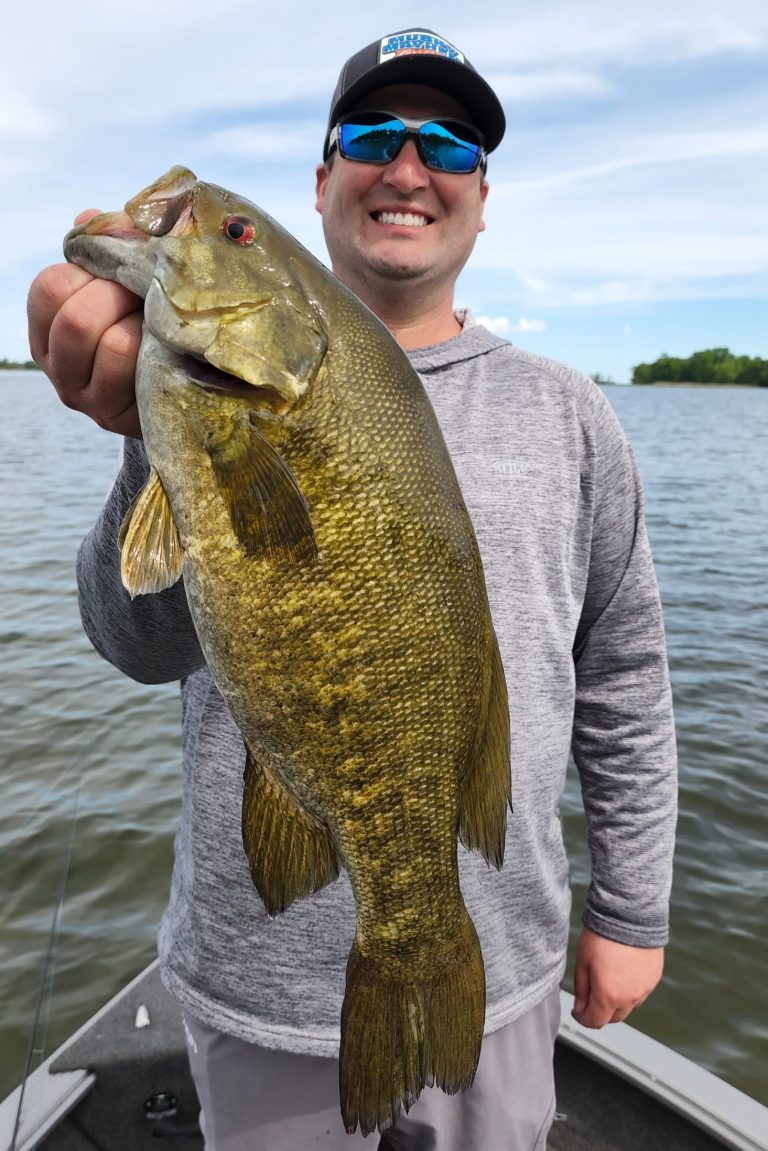 Angler holding a 26-inch fish in Onamia