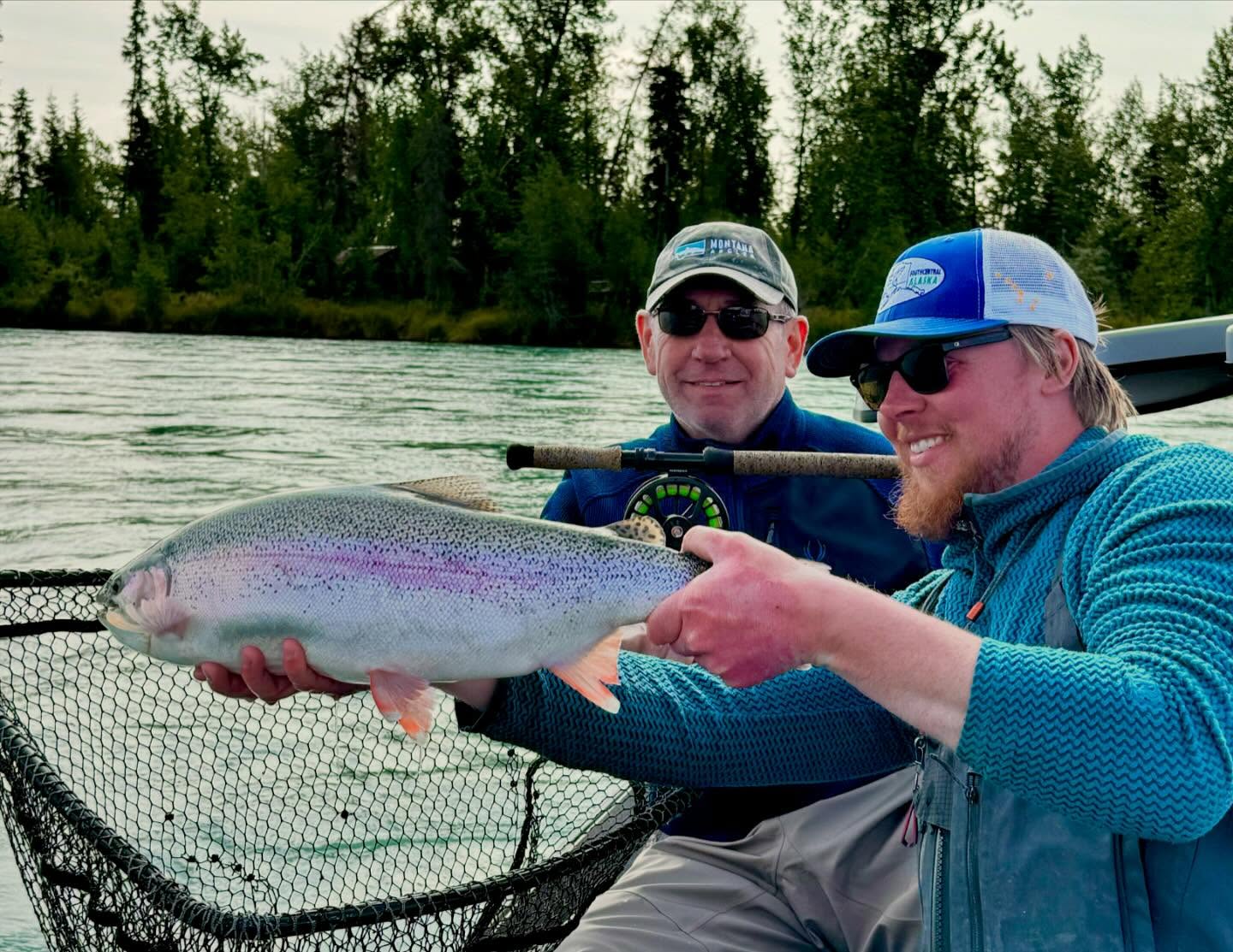 Angler with a rainbow trout, fishing in Sterling