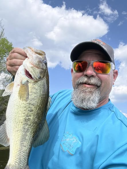 Large bass fish being held up after successful fishing catch in King NC