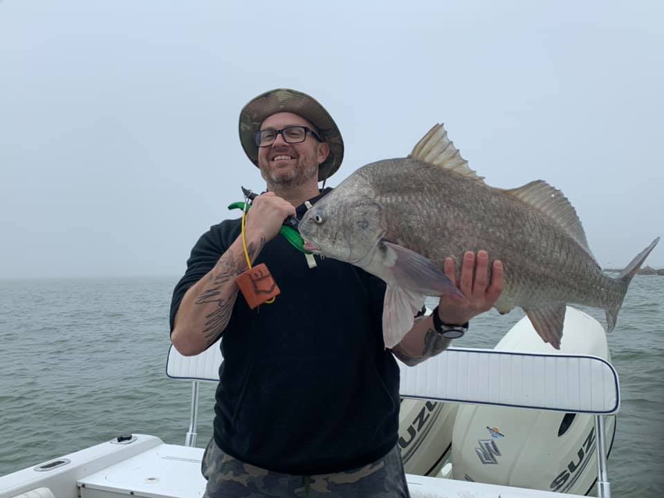 Angler with a large black drum fish caught in TX