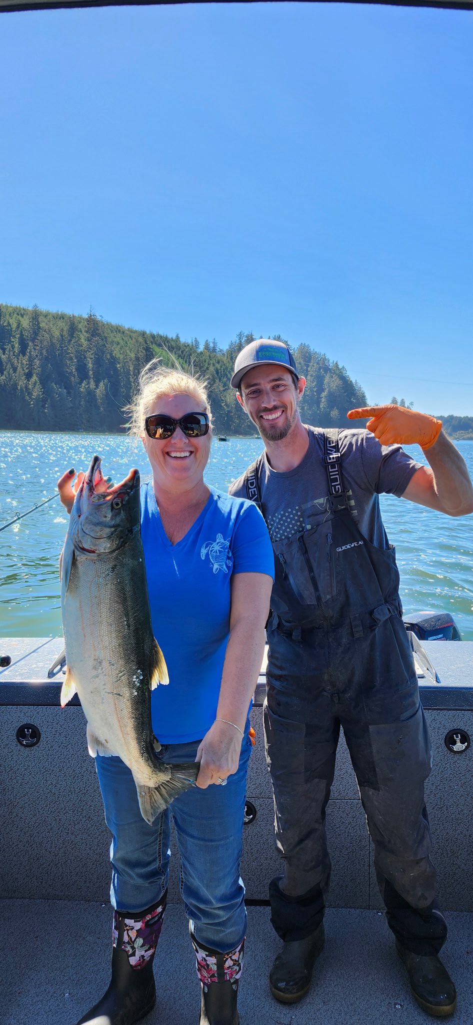 Coho salmon fishing success in Winchester Bay OR with large catch displayed on boat