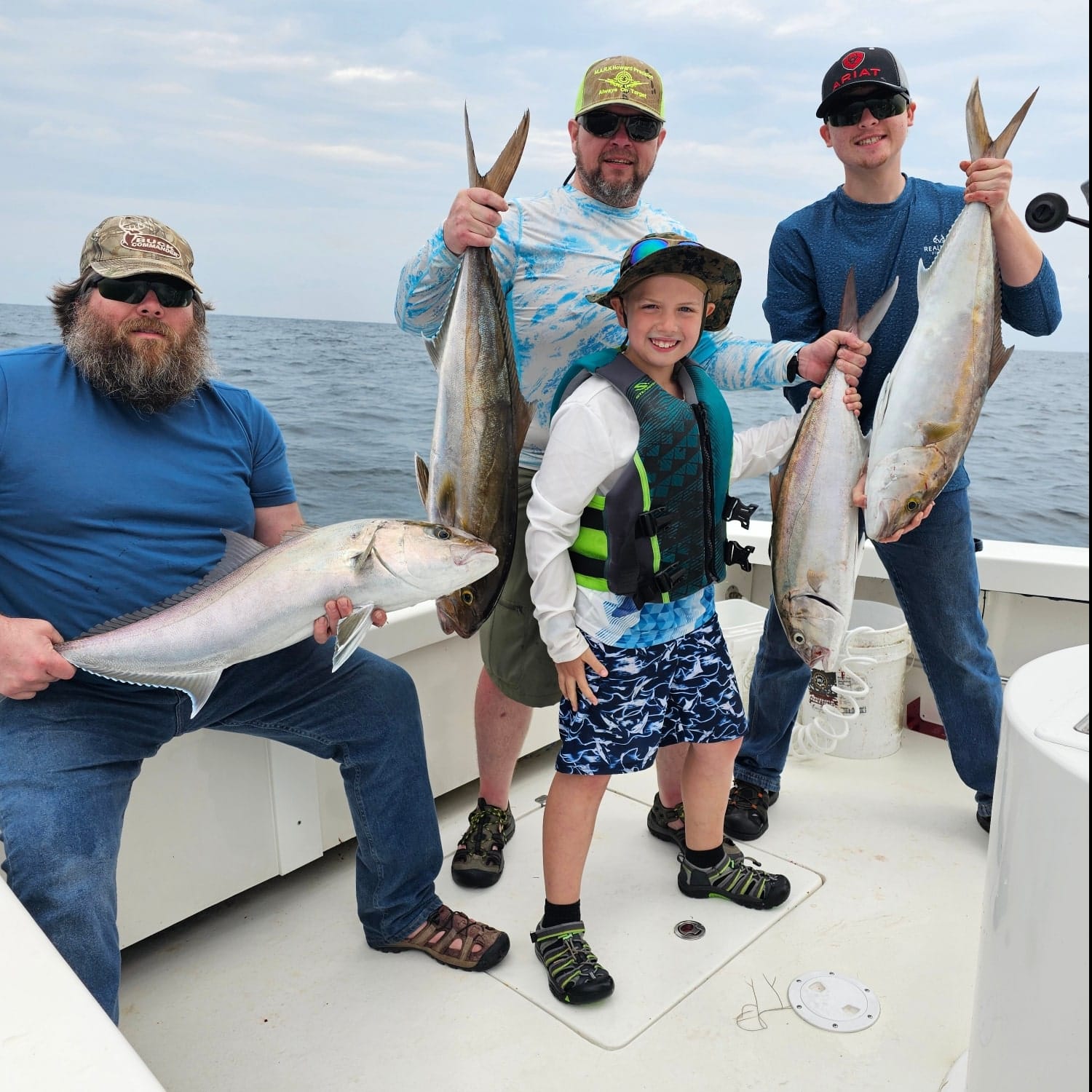 Four greater amberjack and blue runner fish caught in Hatteras