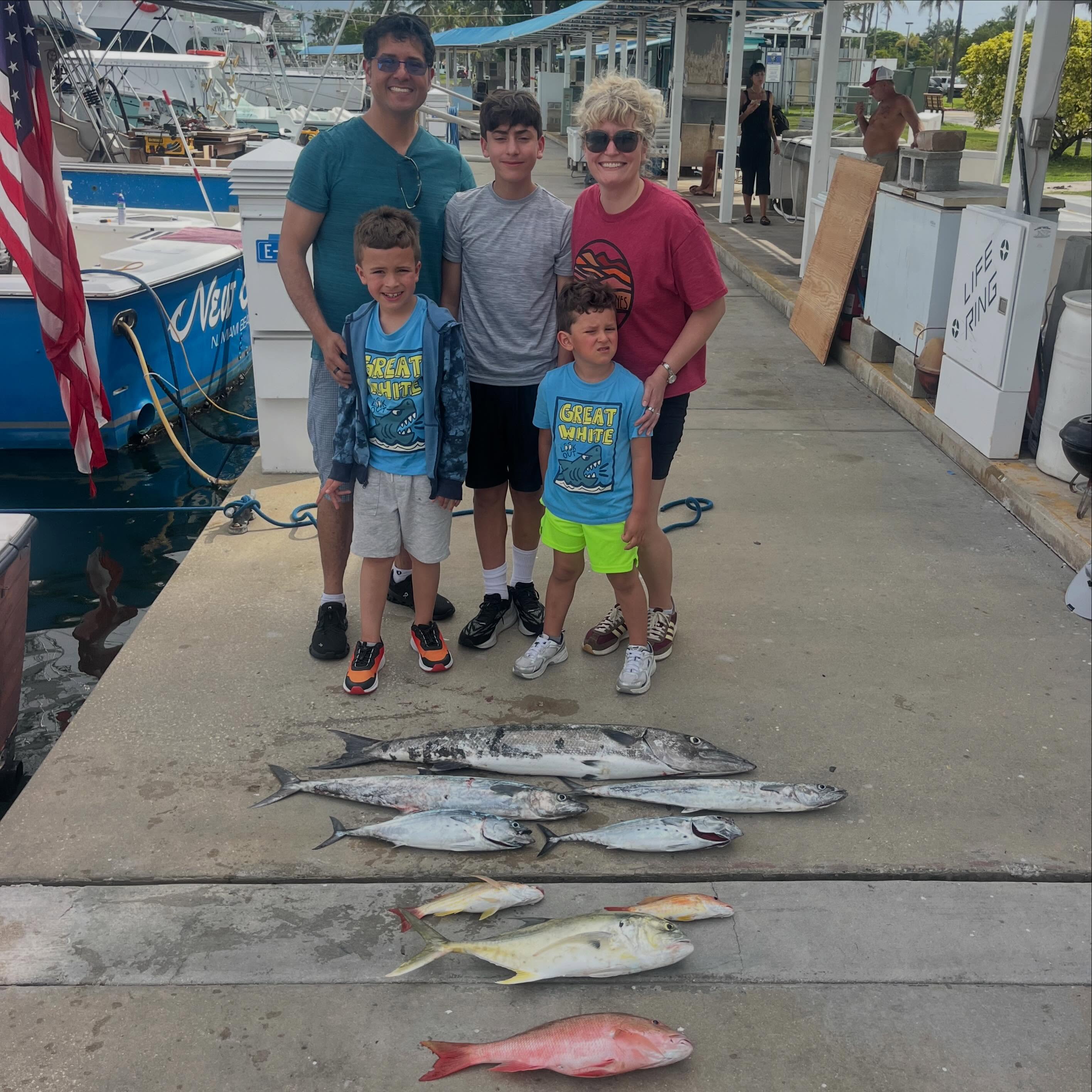 Fishing catch display showing crevalle jack and little tunny with other species on Miami FL dock