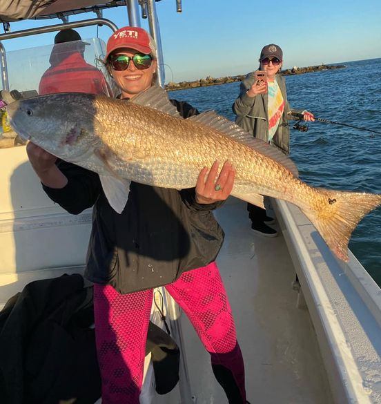 Two people fishing in Apalachicola with a 36-inch fish