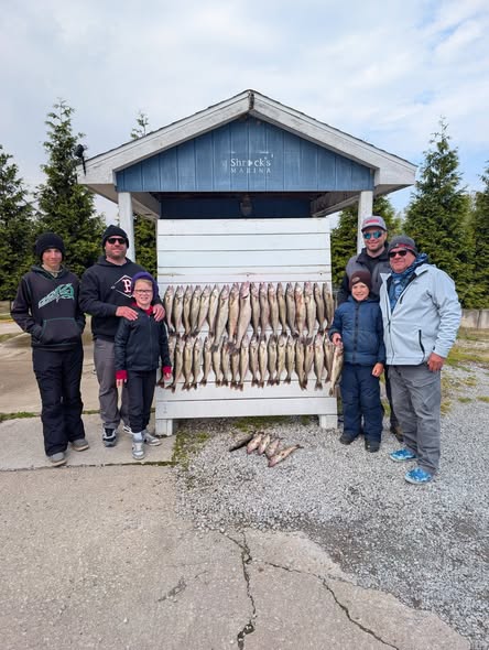 Fishing group displays catch of multiple fish on cleaning station in Port Clinton OH