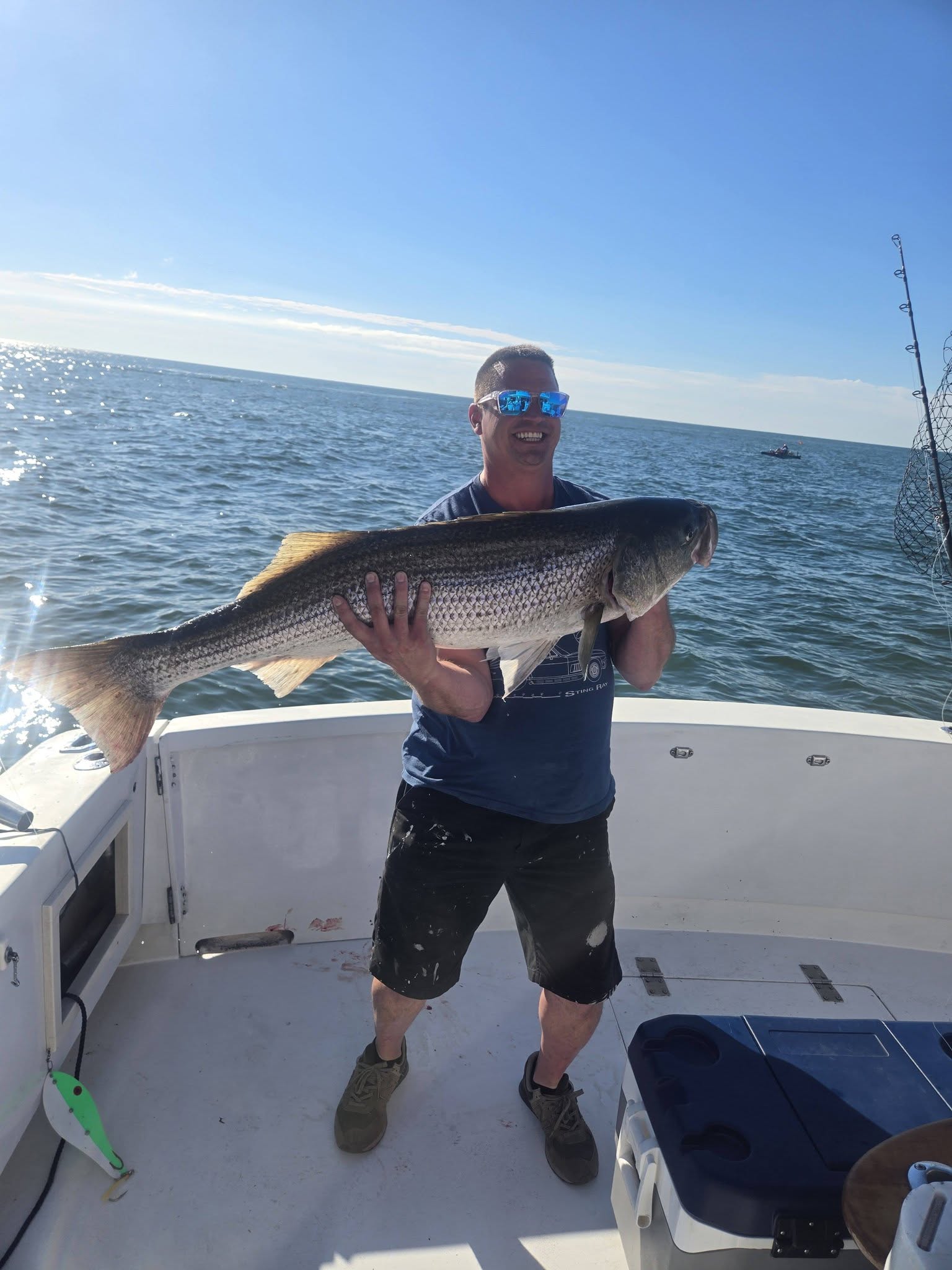 Large striped bass catch displayed on fishing boat deck in Belmar NJ