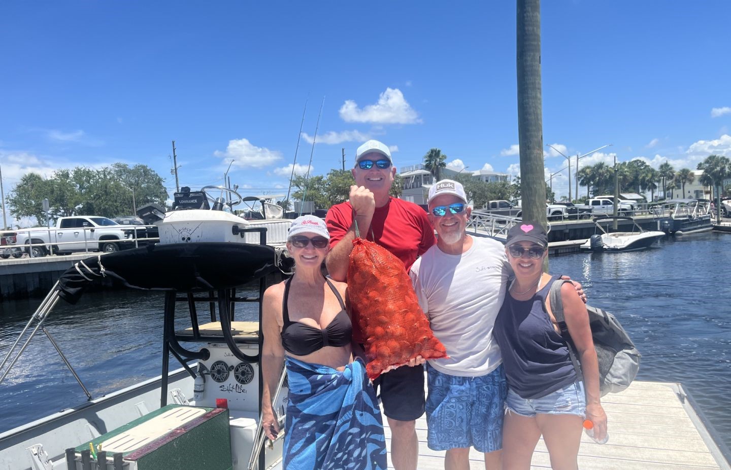 Fishing group at marina dock in Homosassa FL displaying large red grouper catch