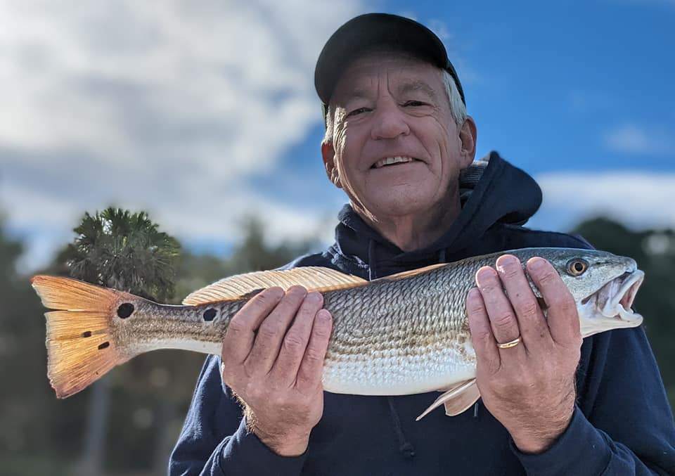 Angler holding a large redfish caught in SC