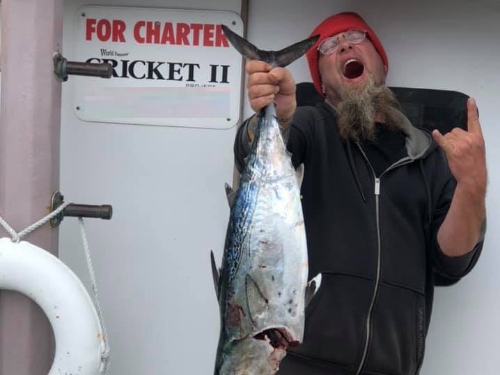 Fisherman holding a large King Mackerel in NC