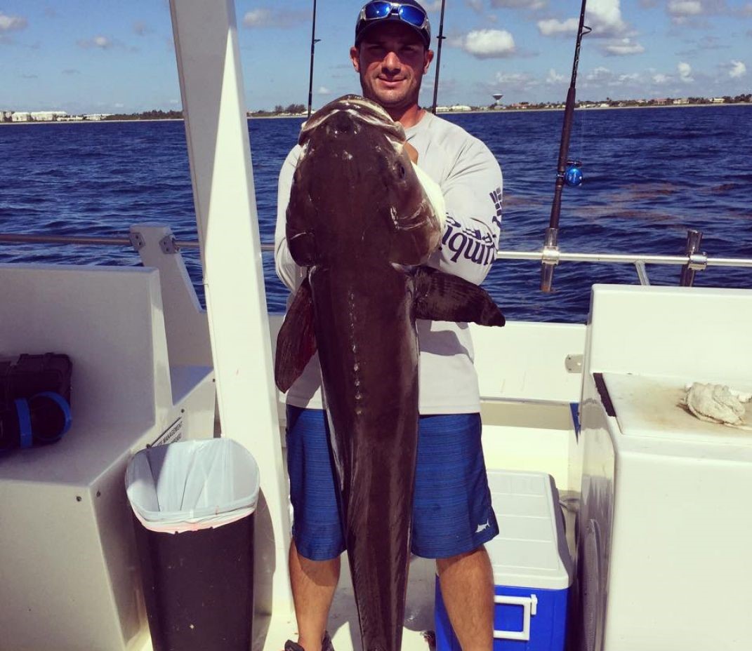 Angler holding a 38-inch fish in Hypoluxo