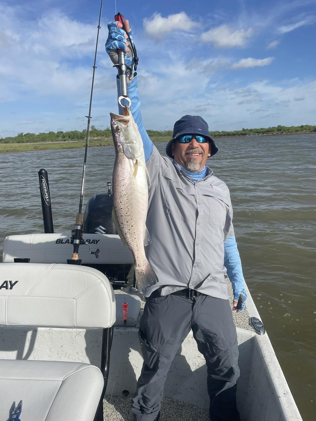 Photograph of a man fishing for a spotted weakfish in TX
