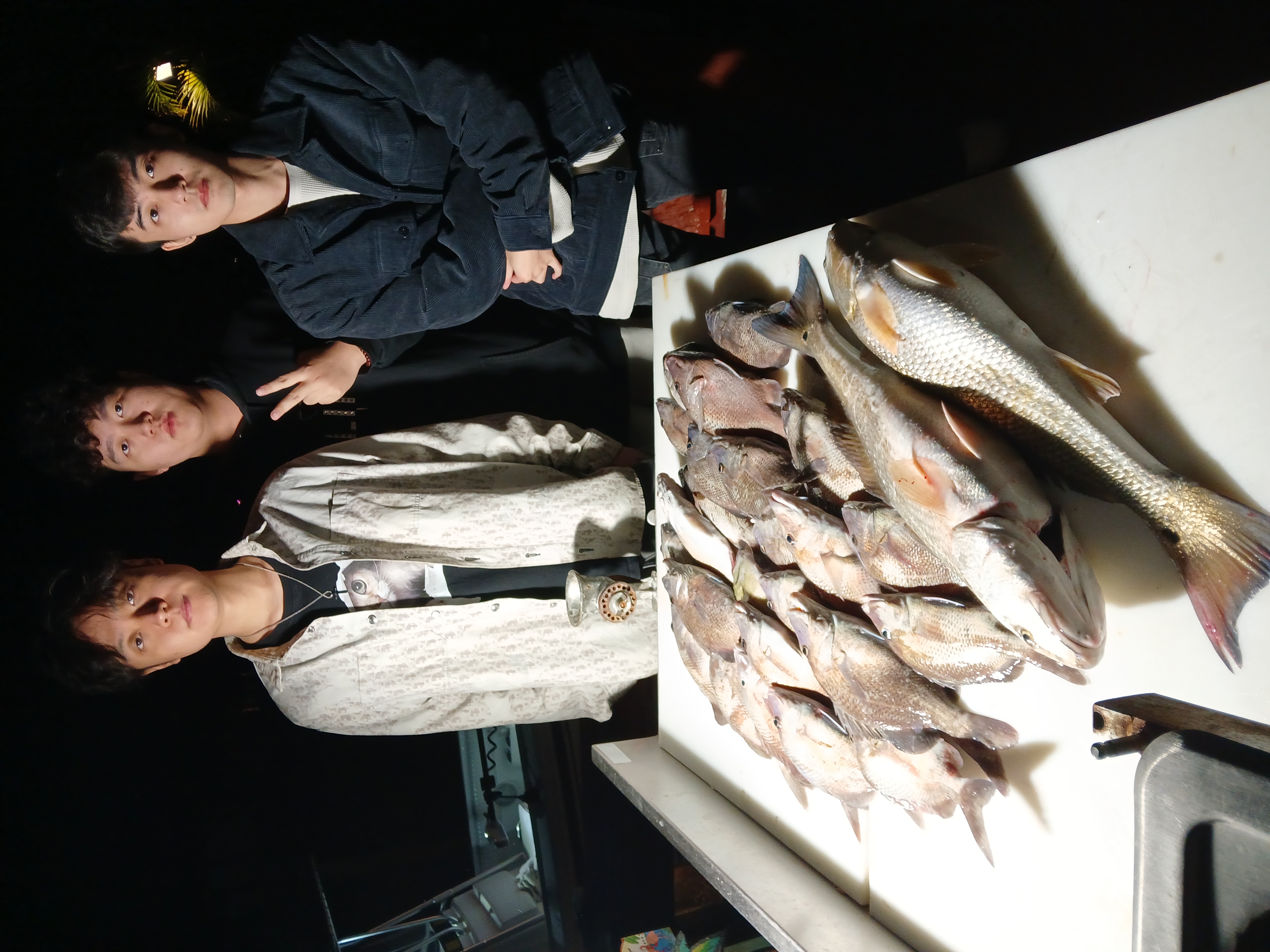 A group of 4 people fishing on Treasure Island